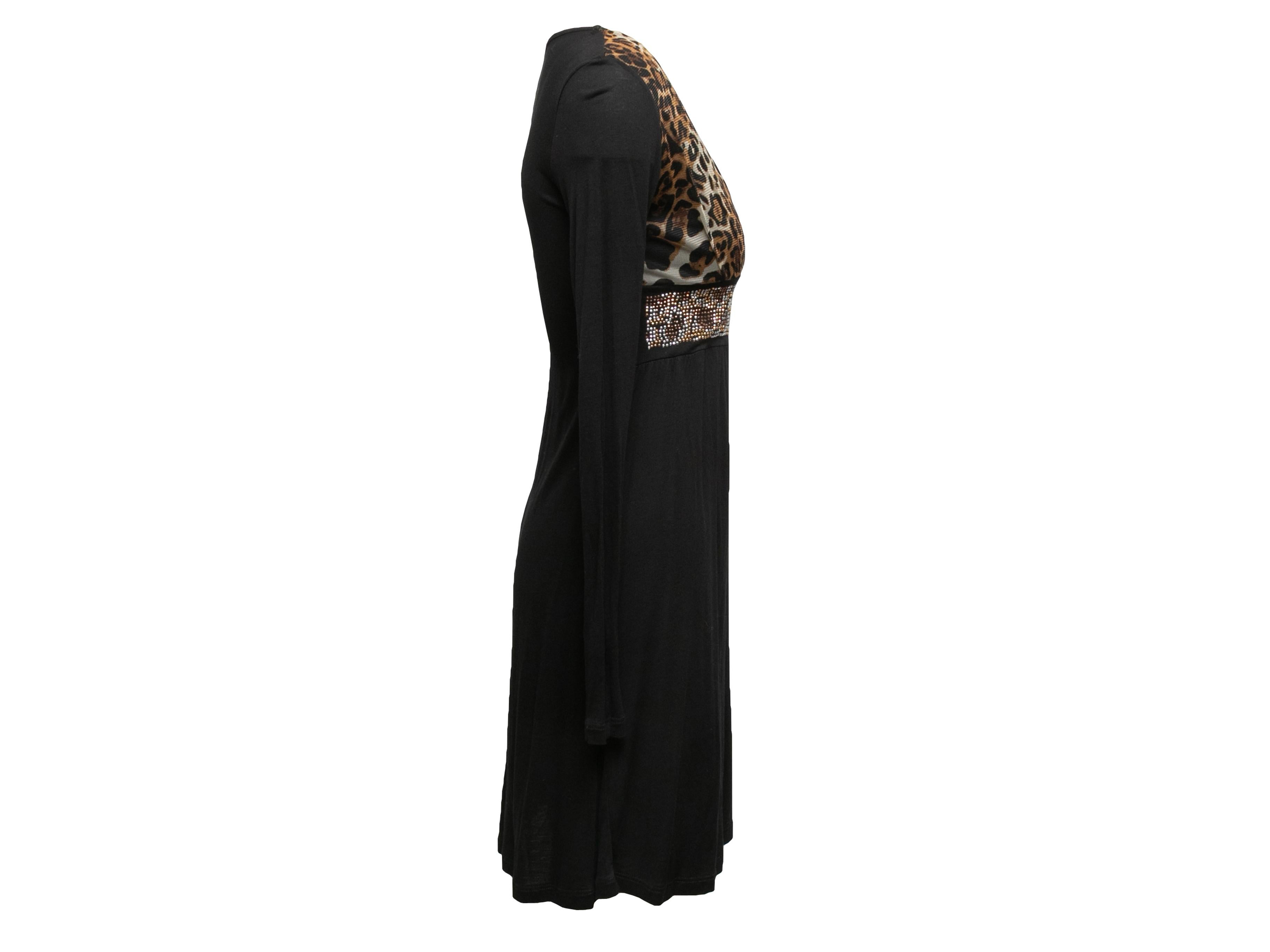 Black and brown long sleeve leopard print mini dress by Roberto Cavalli. V-neck. Rhinestone embellishments at front empire waist. 32