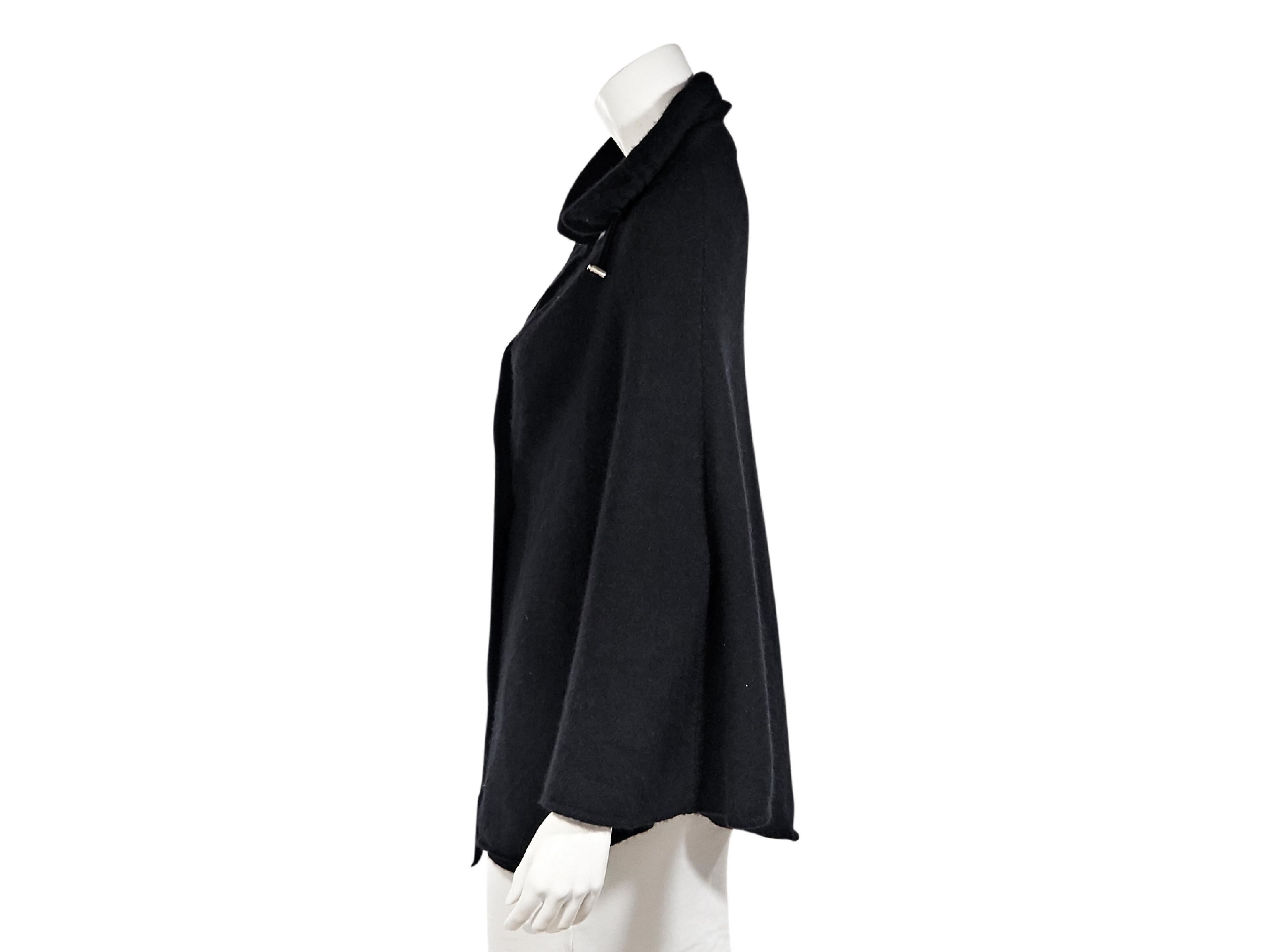 Product details:  Black cashmere cape by Brunello Cucinelli.  Spread collar with drawstring.  Single-button closure.  40