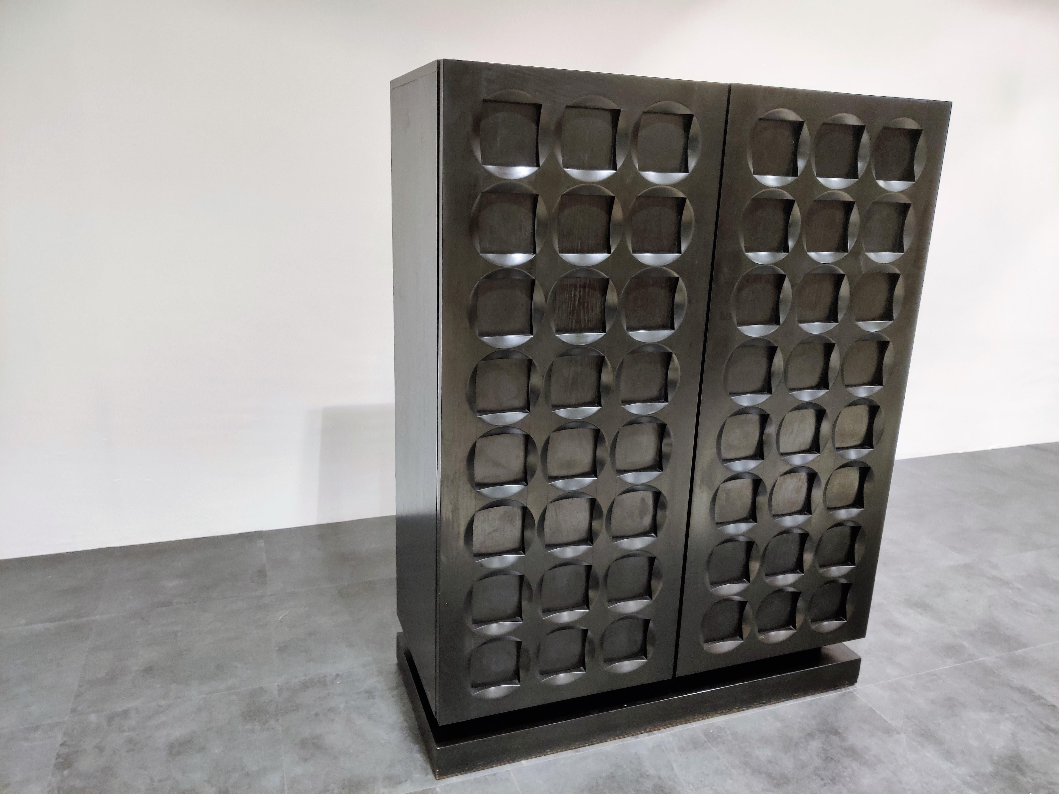 Beautiful black ebonized wooden Brutalist bar cabinet.

Stunning graphical design doors.

Contains a built in bottle holder.

Eye-catching and timeless piece.

Good condition.

1970s, Belgium

Dimensions:
Height 141cm/55.51