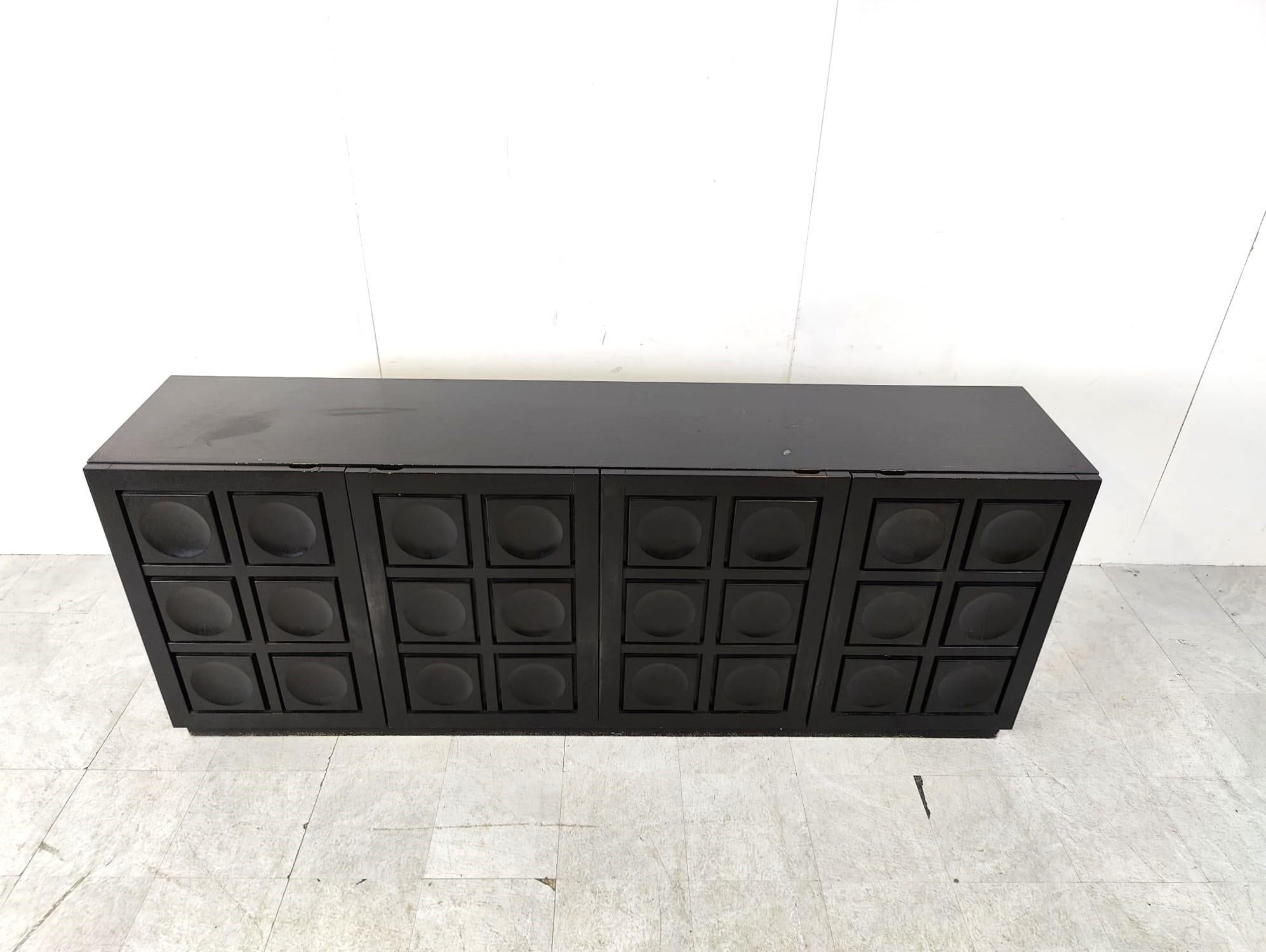 Ebonized black brutalist credenza with 4 graphical doors 

Beautiful timeless design

Good condition

1970s - Belgium

Dimensions:

Height: 87cm
Lenght: 220cm
Depth: 46cm

Ref.: 723483
