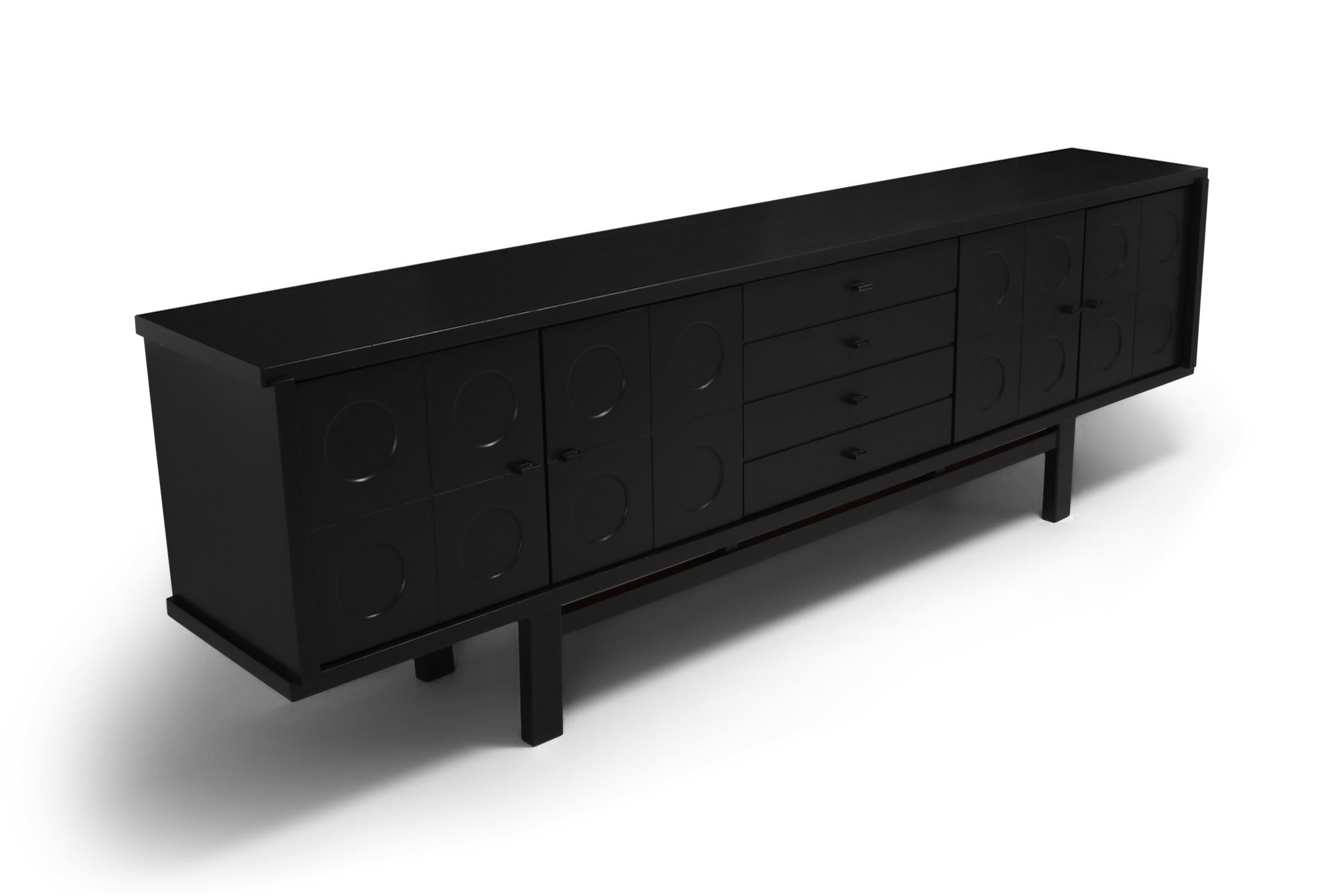 Graphical sideboard made out of ebonized oak. The symmetry of this design combined with the graphical pattern on the doors is adding a brutalist expression to this storage piece. It contains plenty of storage with shells on the inside and 4 drawers