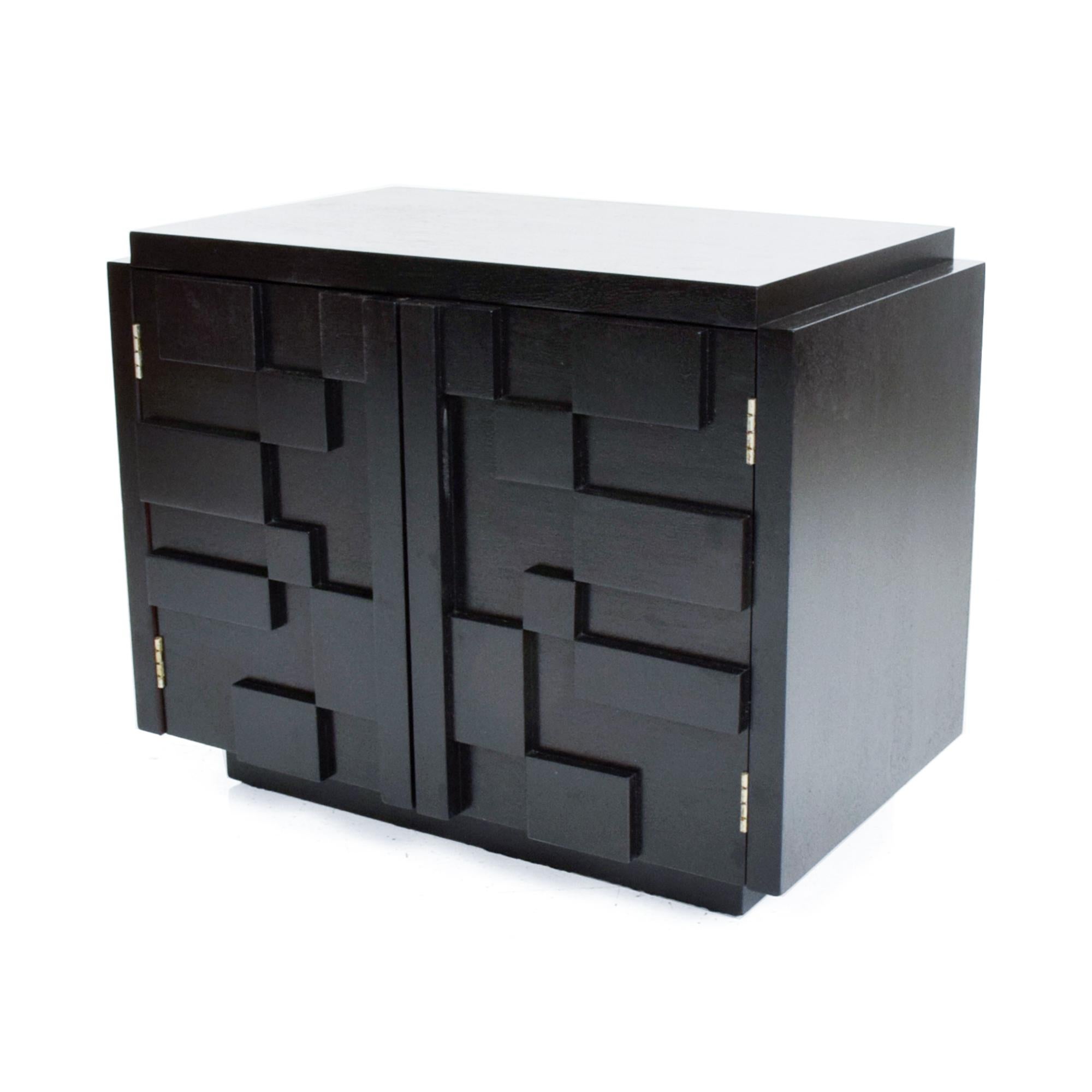 Mid-Century Modern Lane Brutalist nightstand in ebonized walnut wood.
Made by Lane of Altavista VA USA circa the 1970s. Inspired by Paul Evans.
Features two doors with detailed Mosaic patchwork and open storage.
Dimensions: 22.25 H x 27.75W x