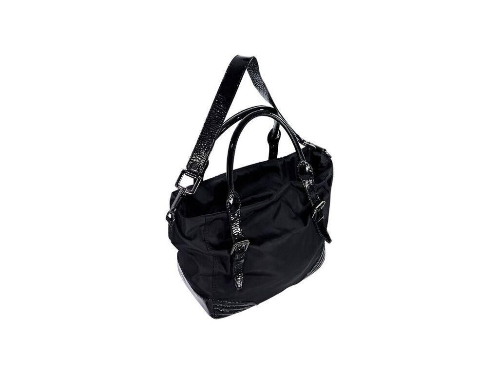 Product details:  Black patent-leather trimmed satchel by Burberry.  Dual carry handles.  Adjustable, detachable shoulder strap.  Top zip closure.  Lined interior with inner zip pocket.  Gunmetal-tone hardware.  Dust bag included.  19