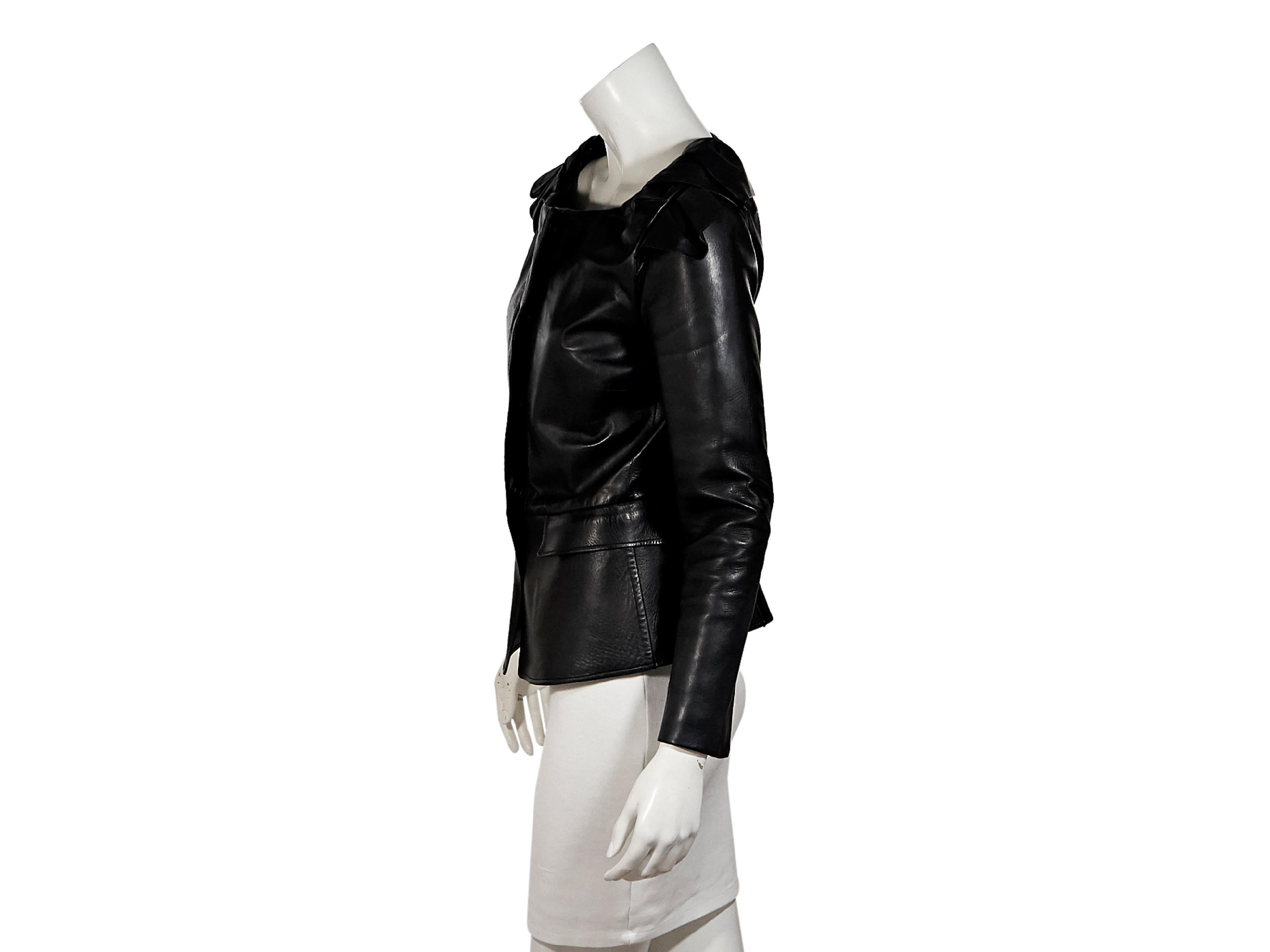 Product details:  Black leather jacket by Burberry Prorsum.  Boatneck.  Off-the-shoulder collar details.  Long sleeves.  Concealed snap-front closure.  Waist flap pockets.  Pleated back hem.  34
