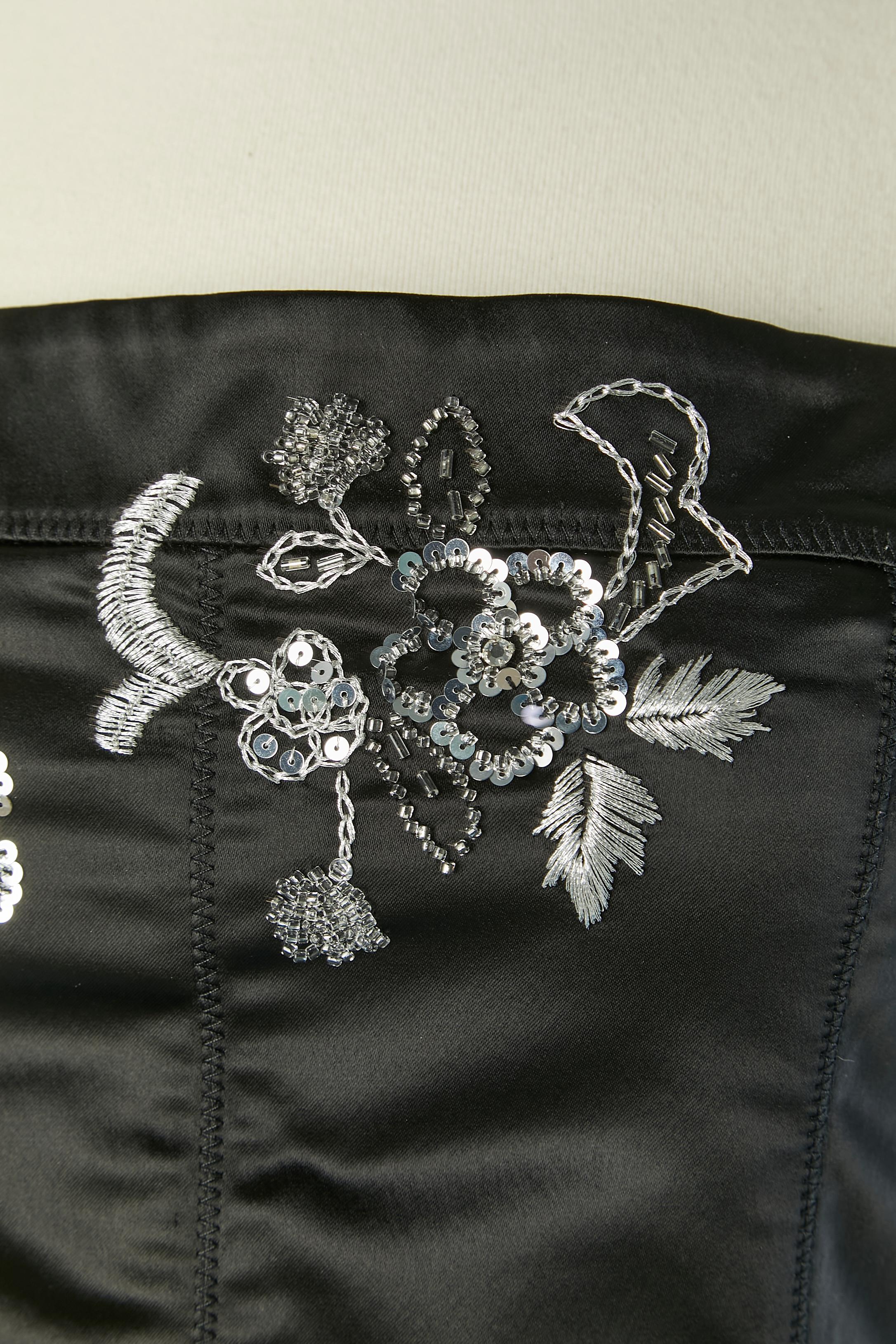 Black bustier dress with silver embroideries ( silver lurex thread, beads and sequins) Fabric composition: 51% acetate, 45% nylon, 4% elastane 
Invisible zip closure on the left side + hook&eye. Authenticity hologram.
SIZE 42 (It) 38 (Fr) M 