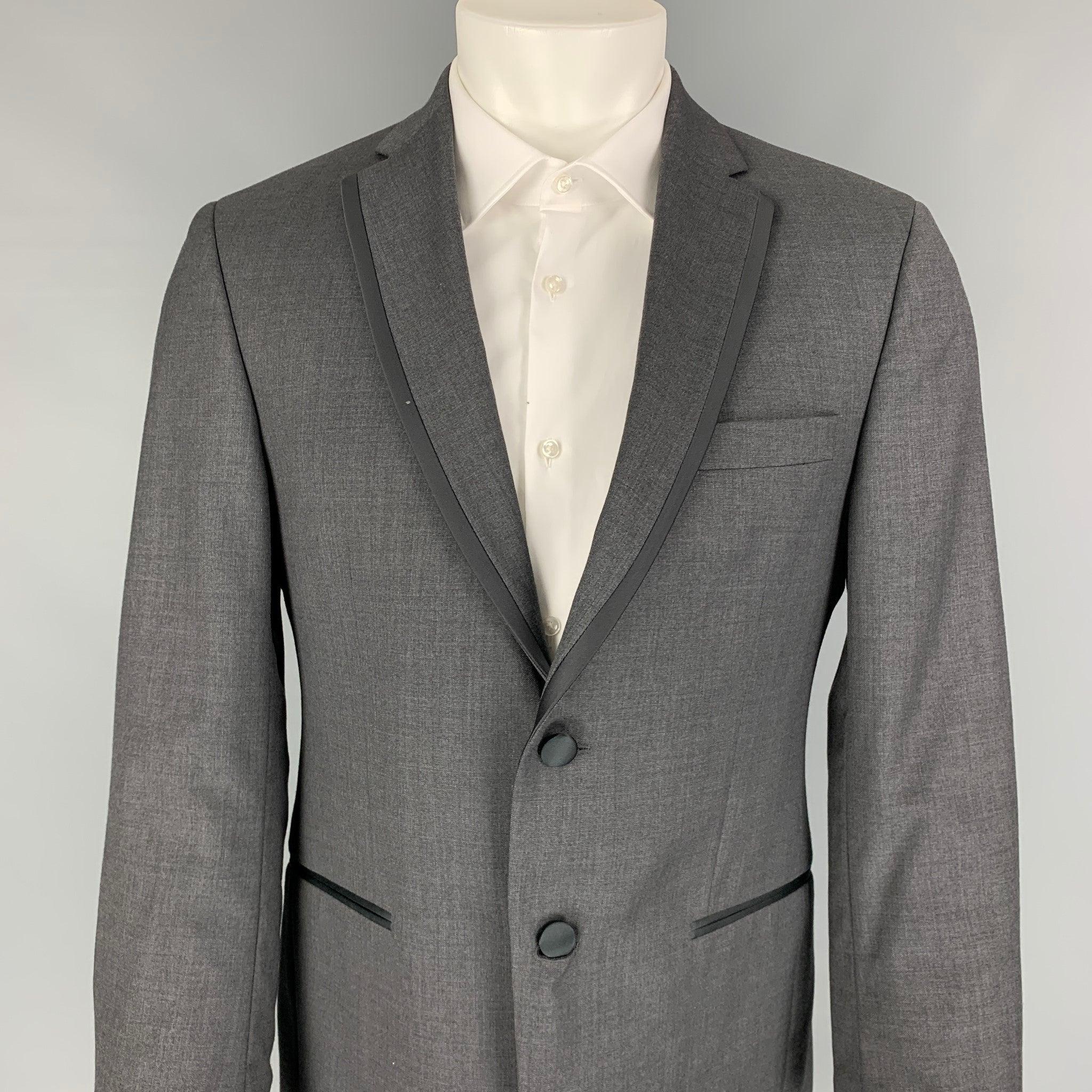 BLACK by VERA WANG sport coat comes in a grey & black wool with a full liner featuring a notch lapel, satin trim, double back vent, slit pockets, and a double button closure.
Excellent
Pre-Owned Condition.  

Marked:   38 

Measurements: 
