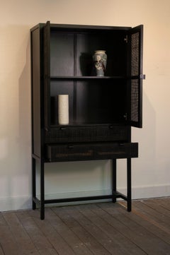 Black cabinet in wood and rattan