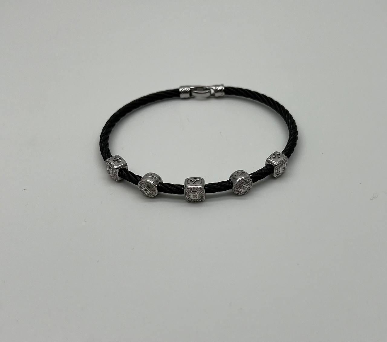 A contemporary bracelet featuring a sleek black twisted cord adorned with square-shaped white diamond accents 0.30 ctw. The diamonds are set in polished white gold, adding a touch of elegance and contrast to the design.