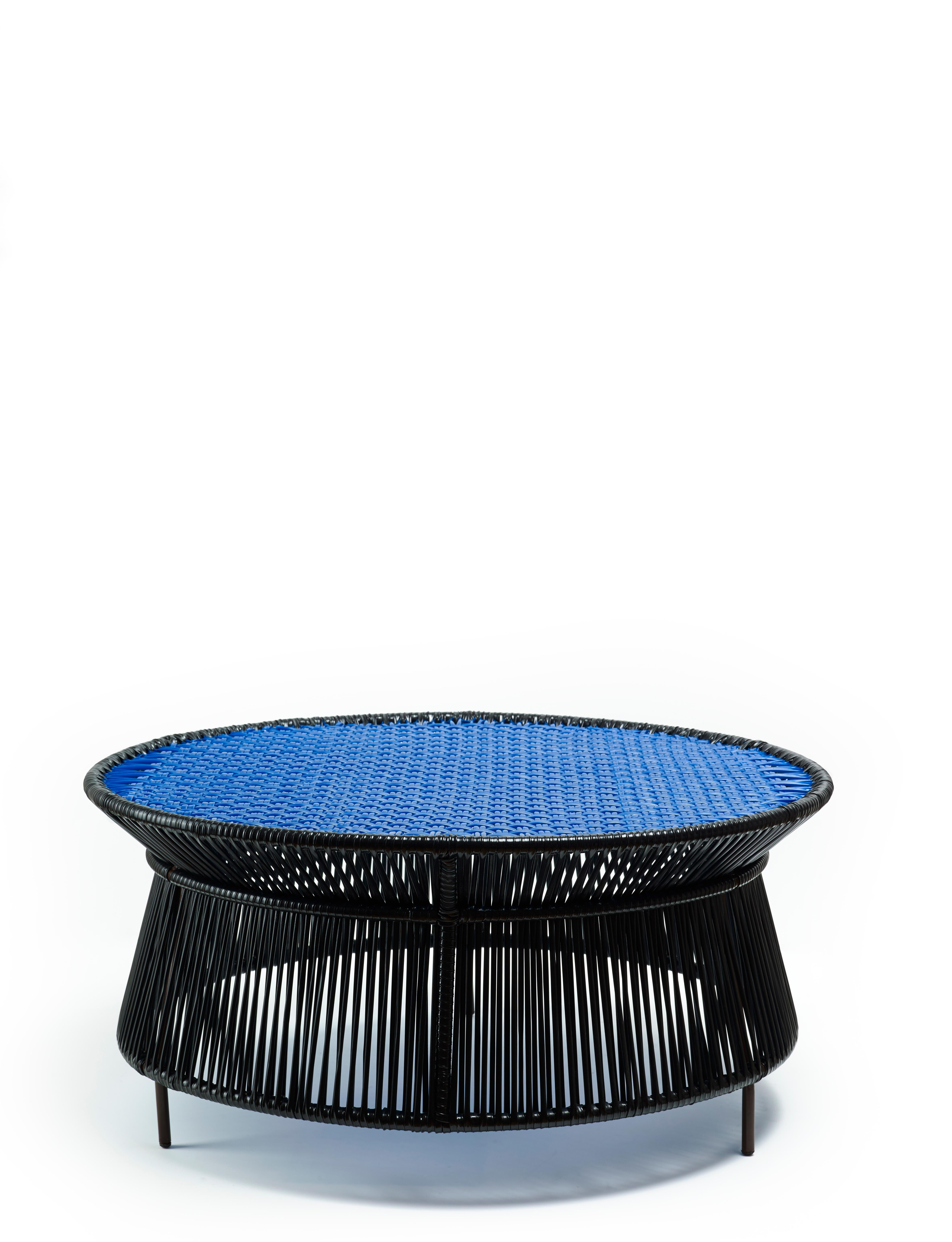 Black Caribe low table by Sebastian Herkner.
Materials: Galvanized and powder-coated tubular steel. PVC strings are made from recycled plastic.
Technique: Made from recycled plastic and weaved by local craftspeople in Colombia. 
Dimensions:
