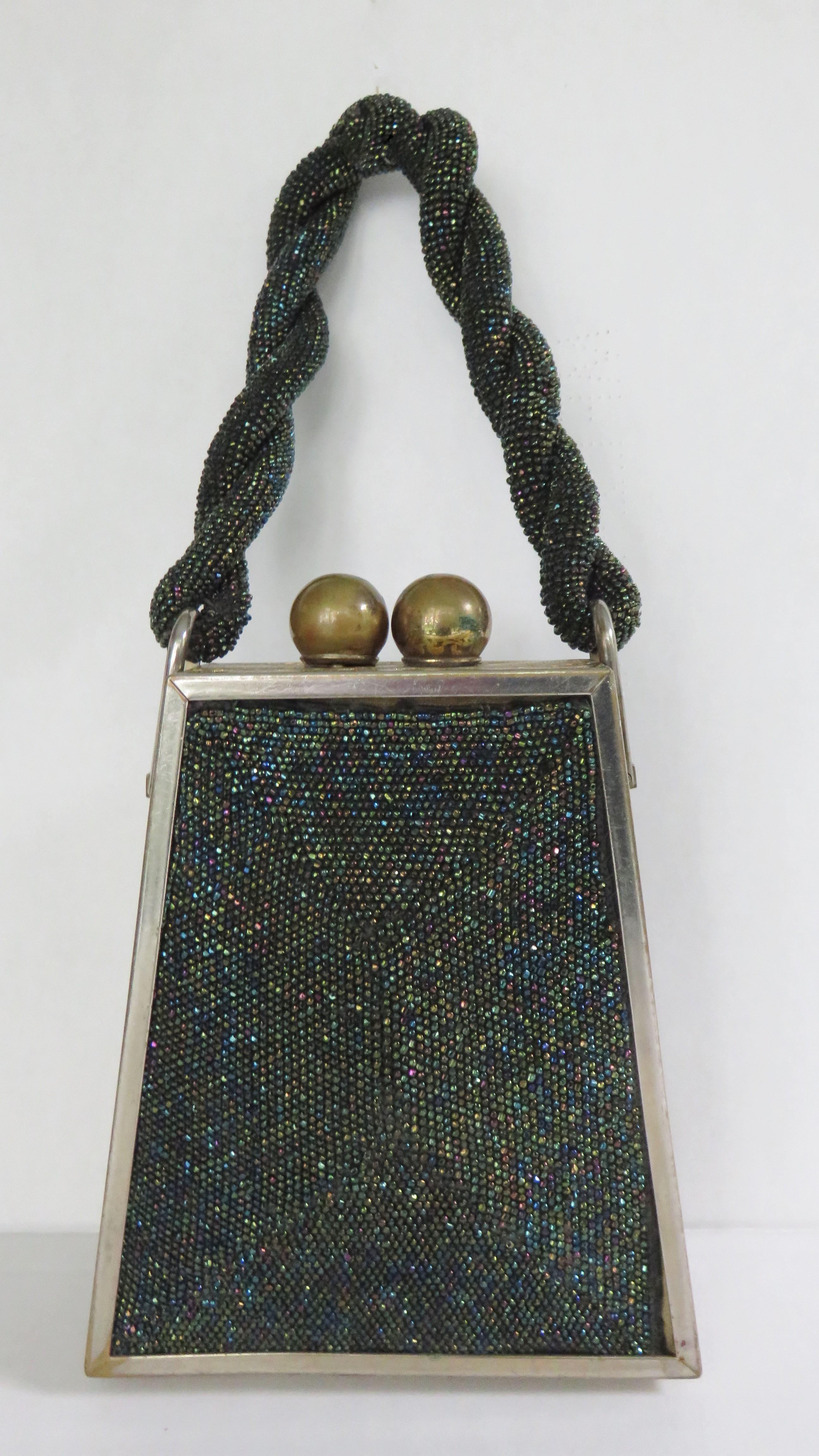 Un magnifique porte-monnaie triangulaire en perles de carnaval en verre noir.  Il est doté d'une poignée torsadée, d'un fermoir à bille en métal doré, d'un cadre élaboré en filigrane de métal doré et d'une doublure en soie avec deux poches