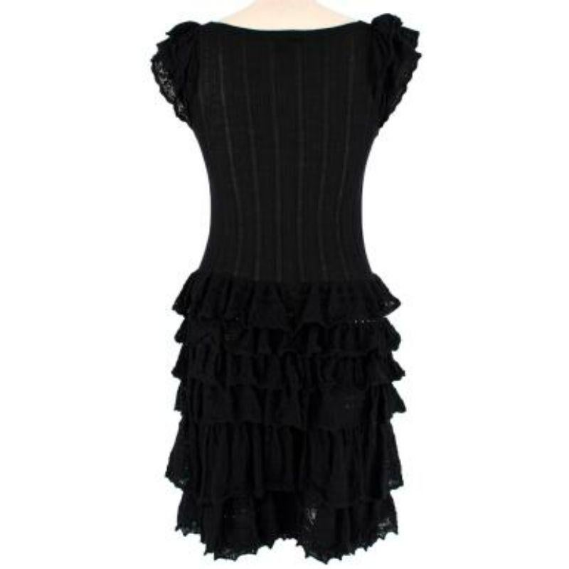 Louis Vuitton
 Black Cashmere & Silk Knitted Ruffle Dress
 

 

 - Luxurious cashmere and silk fine knit with lots of stretch
 - Pearly logo buttons down the front
 - Lace hole and rib details
 - Frilly cap sleeves
 - Layered skirt creating elegant