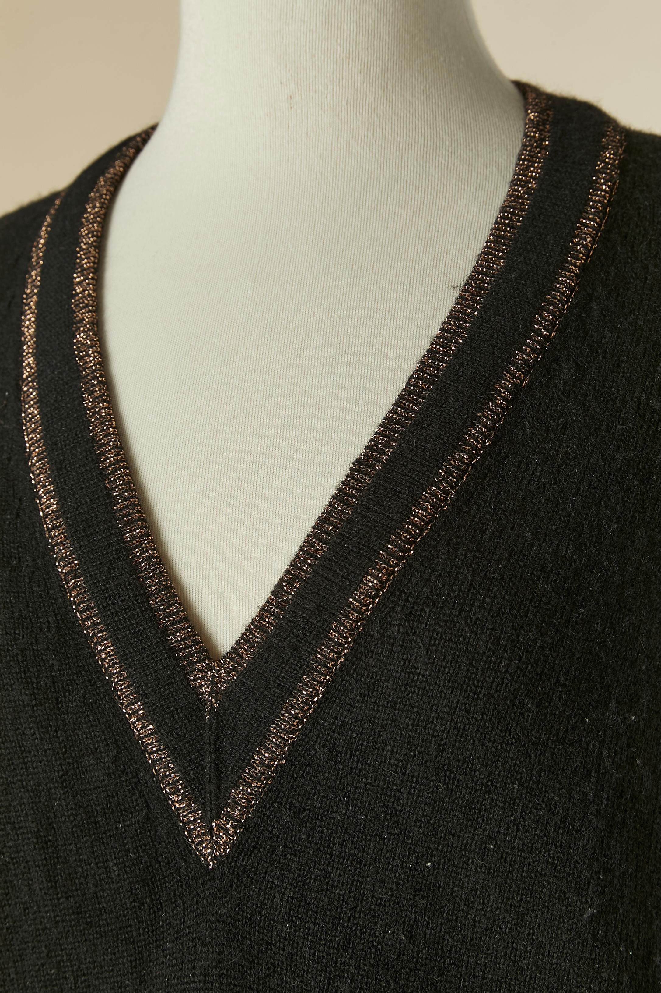 Pull col V en cachemire noir avec bord en lurex.
Composition du tricot : 4% polyester, 2% nylon, 94% cachemire. Pochette 