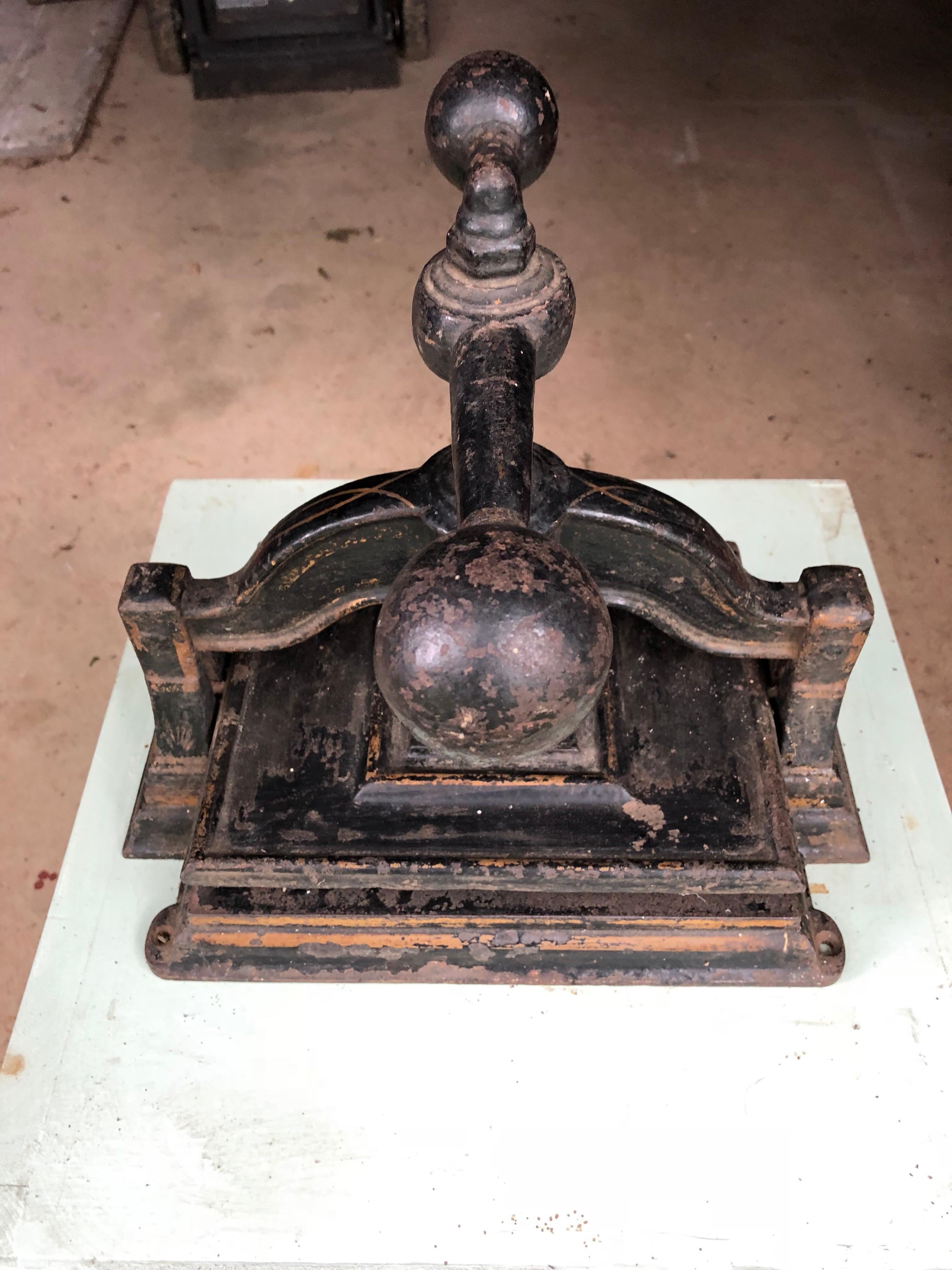 Black cast iron book press with gold decoration. Square base. Screw mechanism with ball shaped handles, circa 1900. Pressing plate holds 9