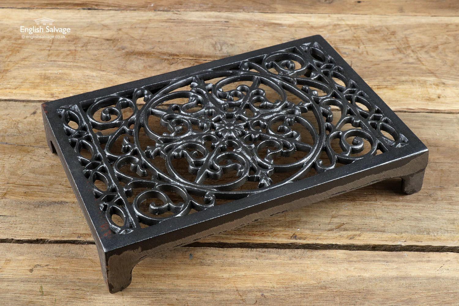 Black painted ornate cast iron trivet or air brick. Very pretty scrollwork throughout. Some of the black paint is missing from most around the 