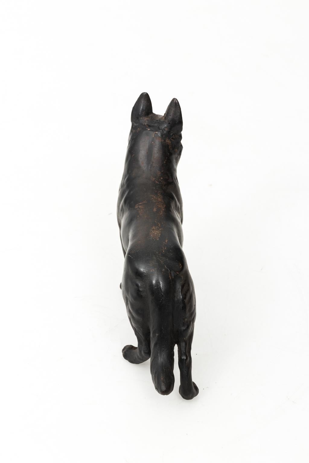 Black painted cast iron German Shepard door stop, circa 1950s. Please note of paint loss due to age. Made in the United States.