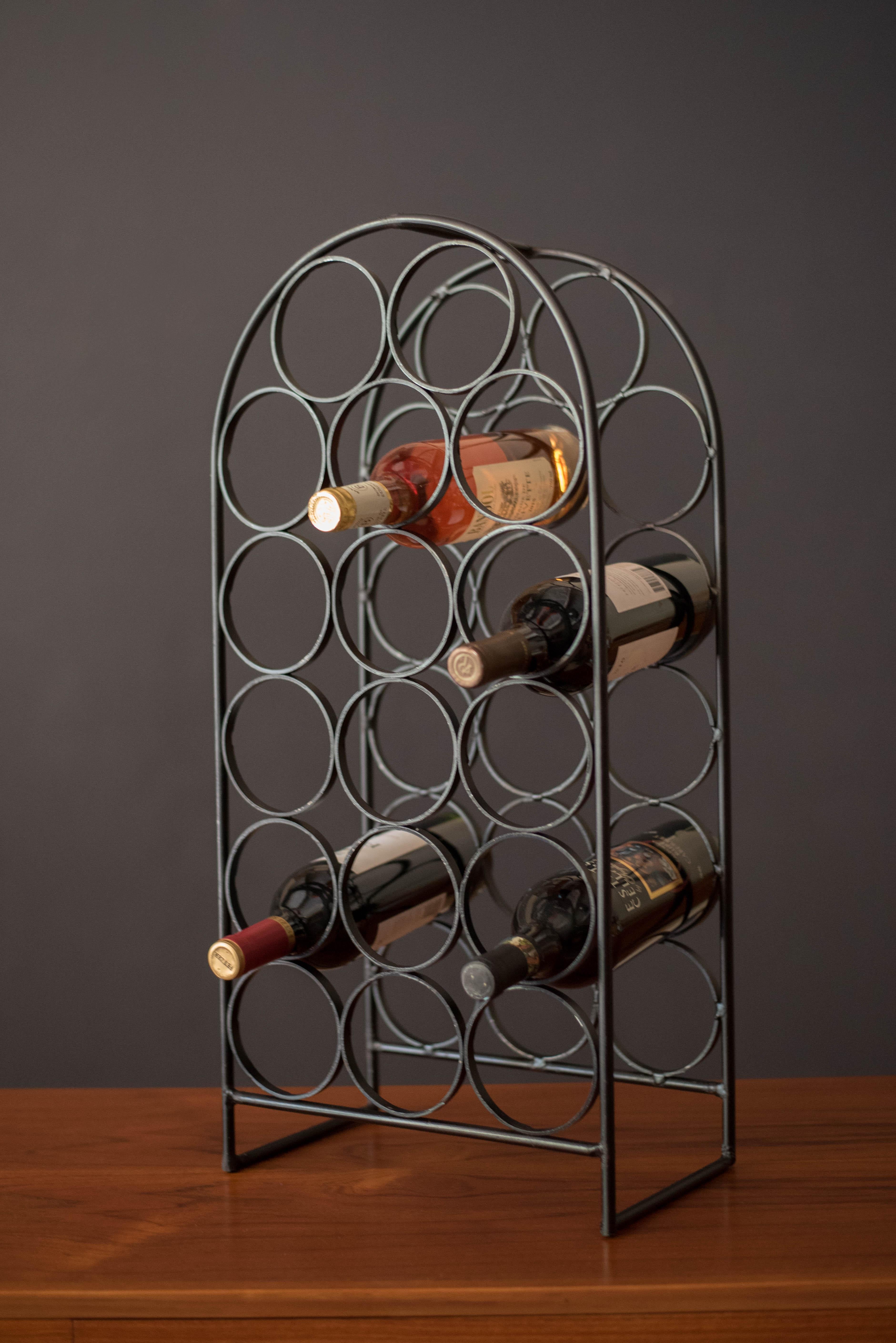 Vintage heavy cast iron wine rack designed by Arthur Umanoff for Shaver Howard, circa 1950's. This piece accommodates up to 17 bottles with plenty of vintage patina. A great accessory for any modern decor collection. 
 

