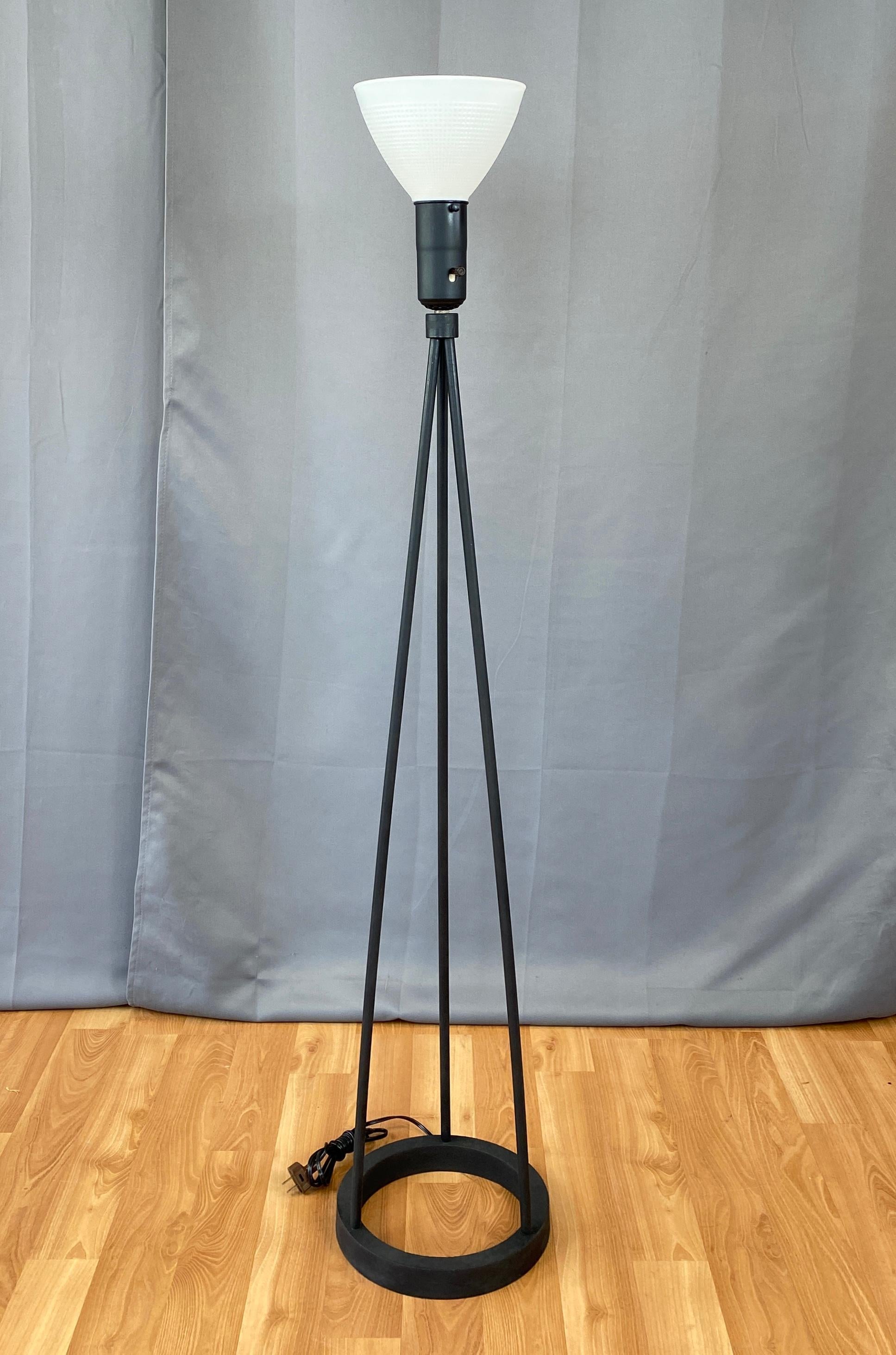 A perfectly proportioned industrial modern postwar floor lamp or torchière by San Francisco designer Robert Bulmore.

Matte black finished cast iron ring base supports a tripod body, combining to form a lamp with clean lines and timeless appeal.