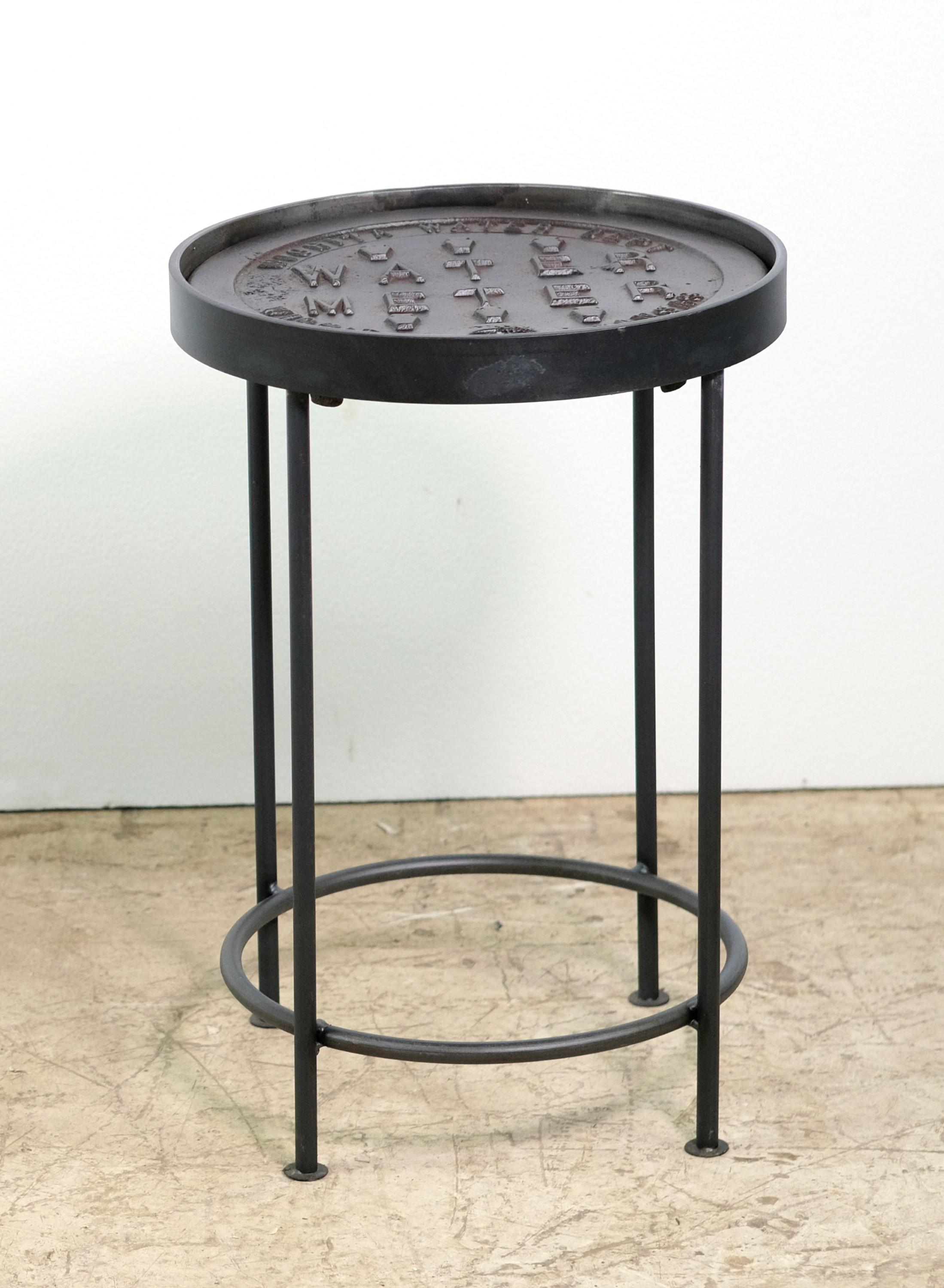 Round top cover is an original cast iron Wichita, KS water meter cover from the Wichita Water Dept. in Kansas. Now reclaimed and made into an Industrial style side table or stool. Top has a slight recess to hold a small round table top. Matching
