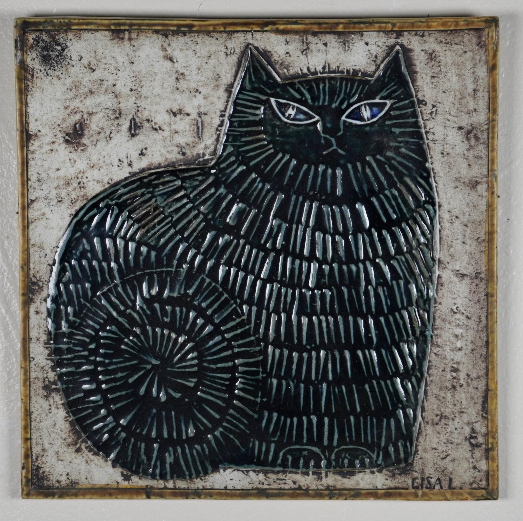 Black cat with blue eyes ceramic hanging wall tile / plaque by Swedish ceramic artist Lisa Larson (born 1931- ) circa 1960s. Square ceramic tile with raised (relief) texture on the body for the cats fur with a black glaze, the eyes have a hint of