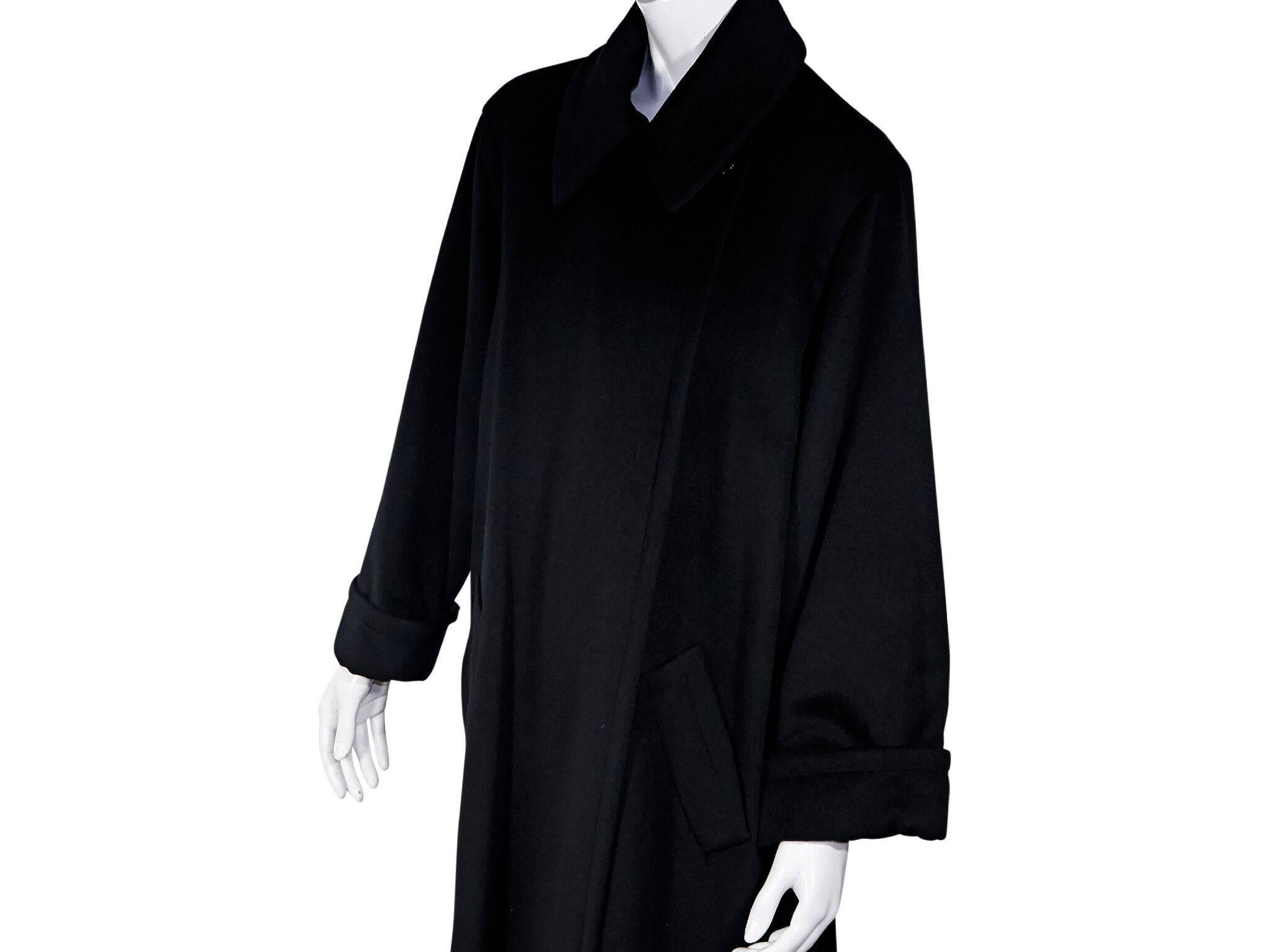 Product details:  Black cashmere and wool blend coat by Celine.  Point collar.  Long sleeves.  French cuffs.  Waist slide pockets.  52