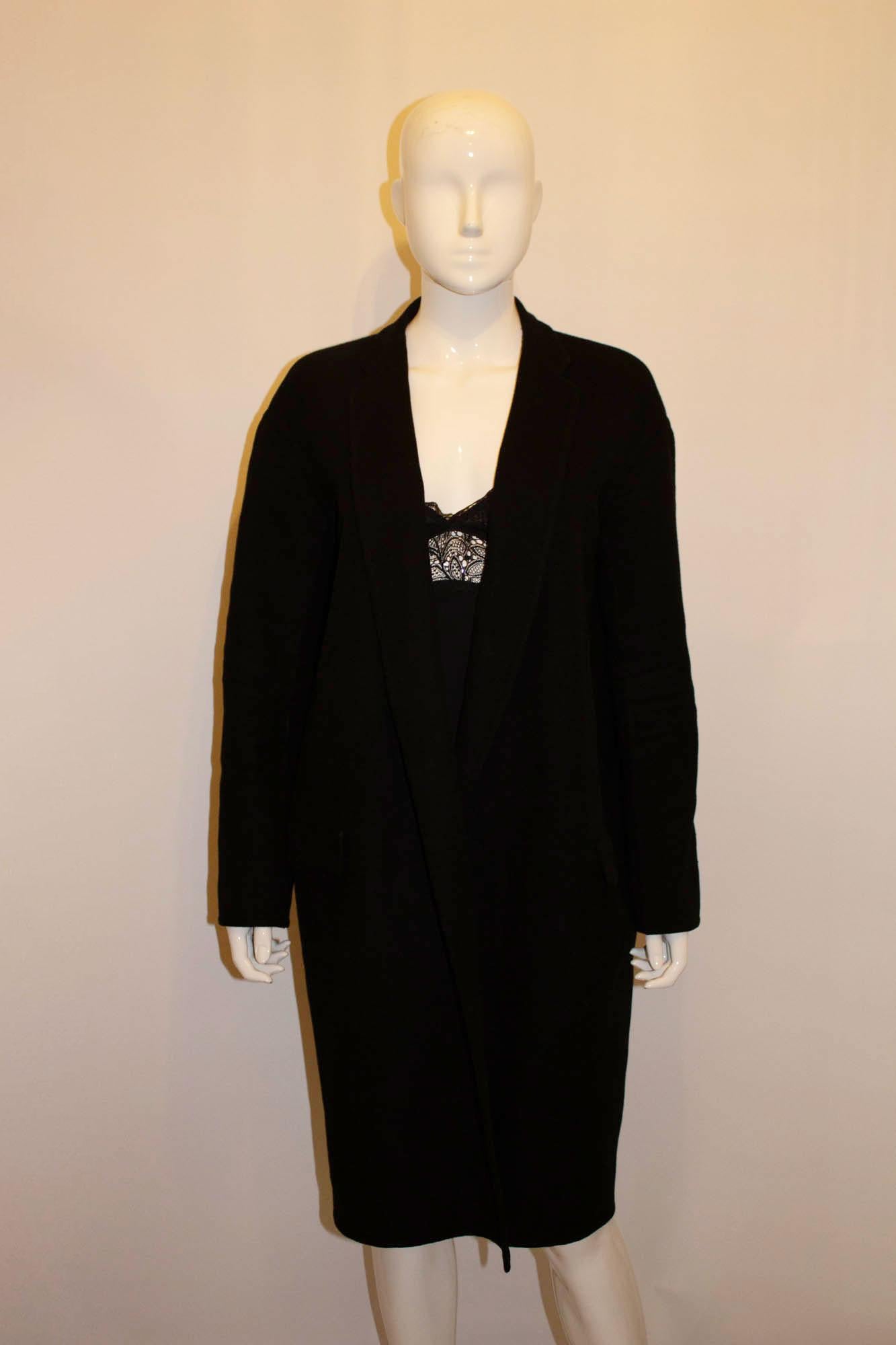 An ultra chic cashmere coat by Celine. This black coat is made in Italy, unlined apart from the sleaves that are lined in mulberry silk. It has a pocket on either side. Size 36, Bust up to 38'', length 40''