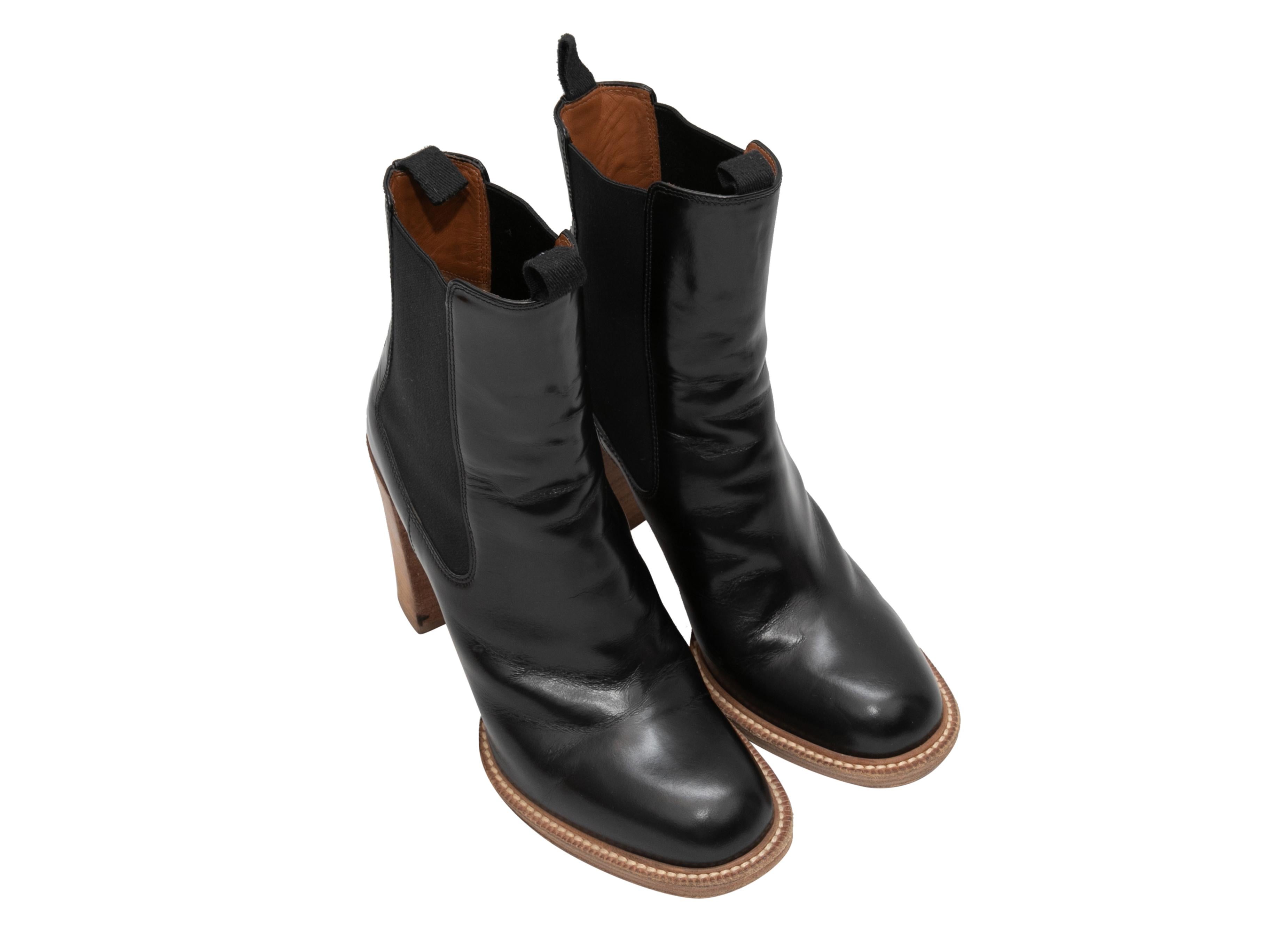 Black leather heeled ankle boots by Celine. Elasticized gores at sides. Stacked heels. 5.25