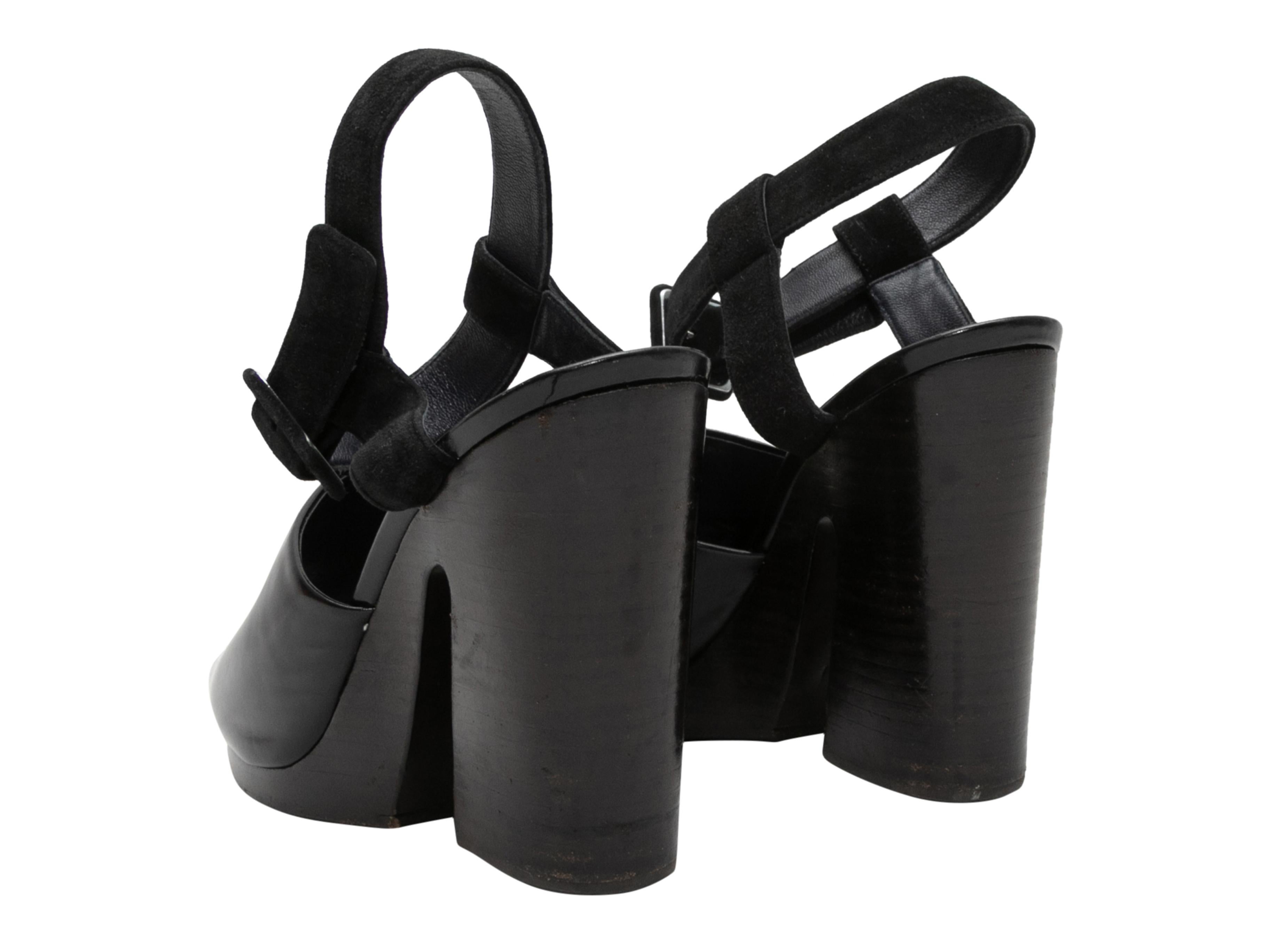 Black patent and suede platform sandals by Celine. Stacked heels. Buckle closures at ankle straps. 0.25
