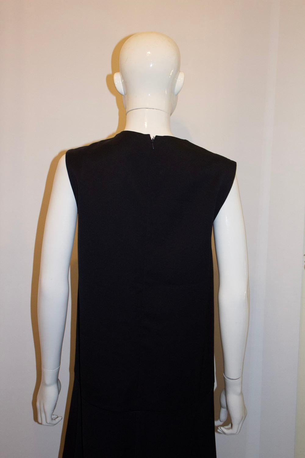 A chic black shift dress by Celine.  The dress is in an acetate mix and lined in silk. It has a flared hem area , and a pocket on either side and back zip opening. Size EU 42 , measurements Bust up to 39'', length 43''