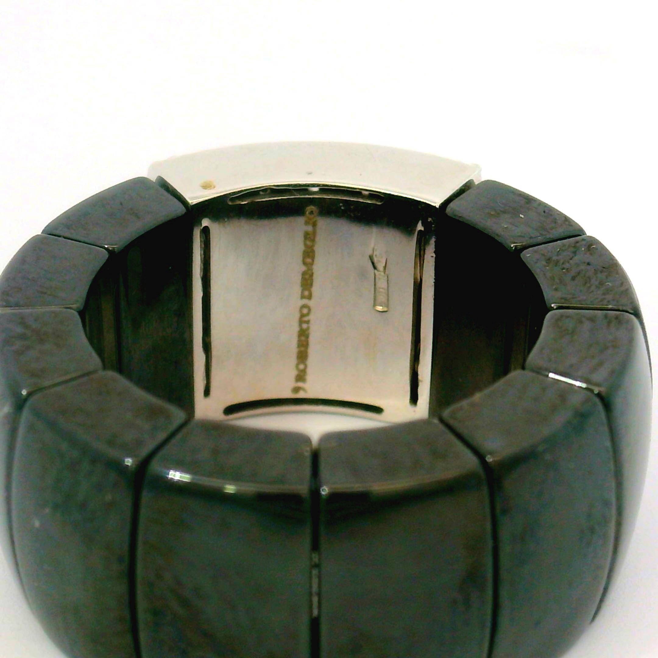 
Black ceramic expandable ring with 18kt white gold pave diamond center by Roberto Demelgio.  The ring has 98 round brilliant diamonds approximately 1.0ctw in weight pave set in 18kt white gold.    The diamonds are VS/SI clarity and F/G color.  The