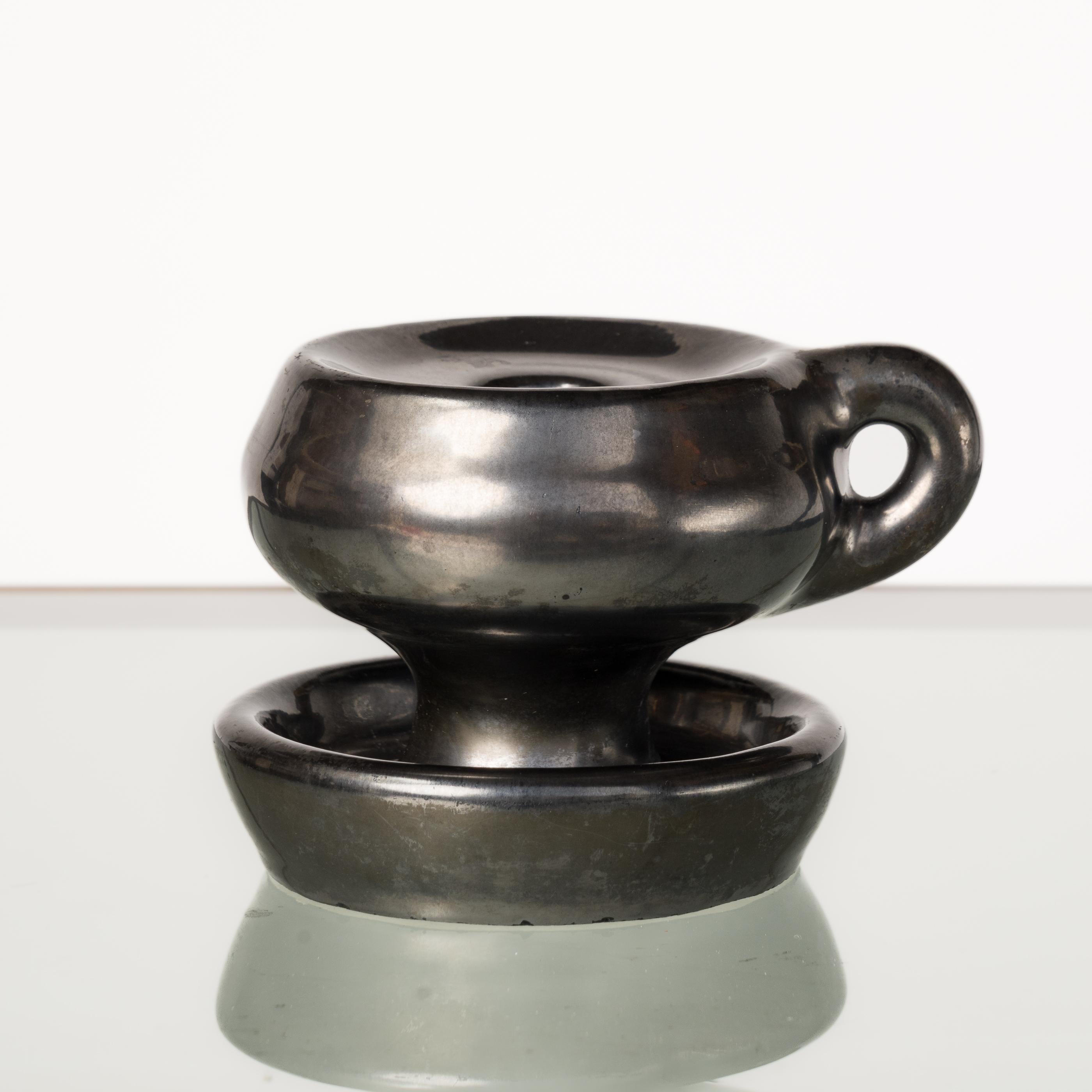 Dark glazed black ceramic candle holder in the style of Jouve. In good vintage condition. This item will ship from France and can be returned to either France or to a LIC NY location.
Price does not include shipping nor possible customs duties