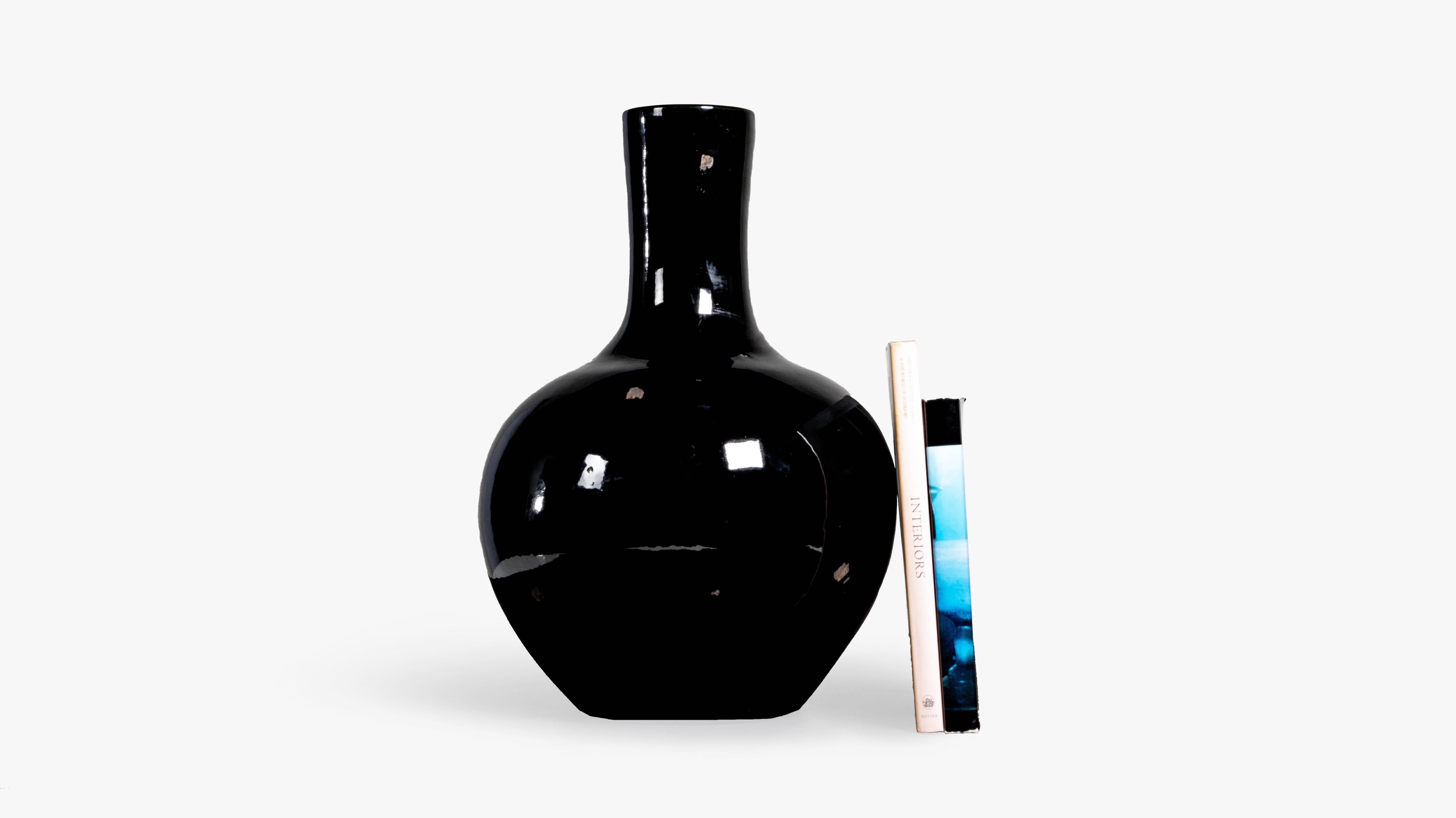 This vase features a beautiful black glaze which is the perfect way to add depth and contrast to any space. This vase can fit within nearly any interior design style from traditional to transitional and mid century modern. 

This piece is a part