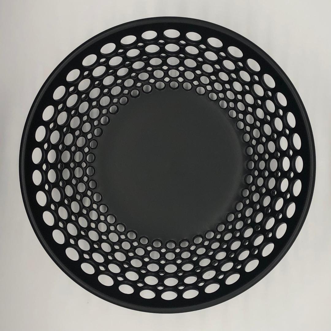 Inspired by Mid-Century Modern design, the bowl is wheel thrown and hand pierced in white stoneware with a black matte glaze. Small holes are created when the clay is still wet and then each hole is painstakingly enlarged and smoothed when the clay