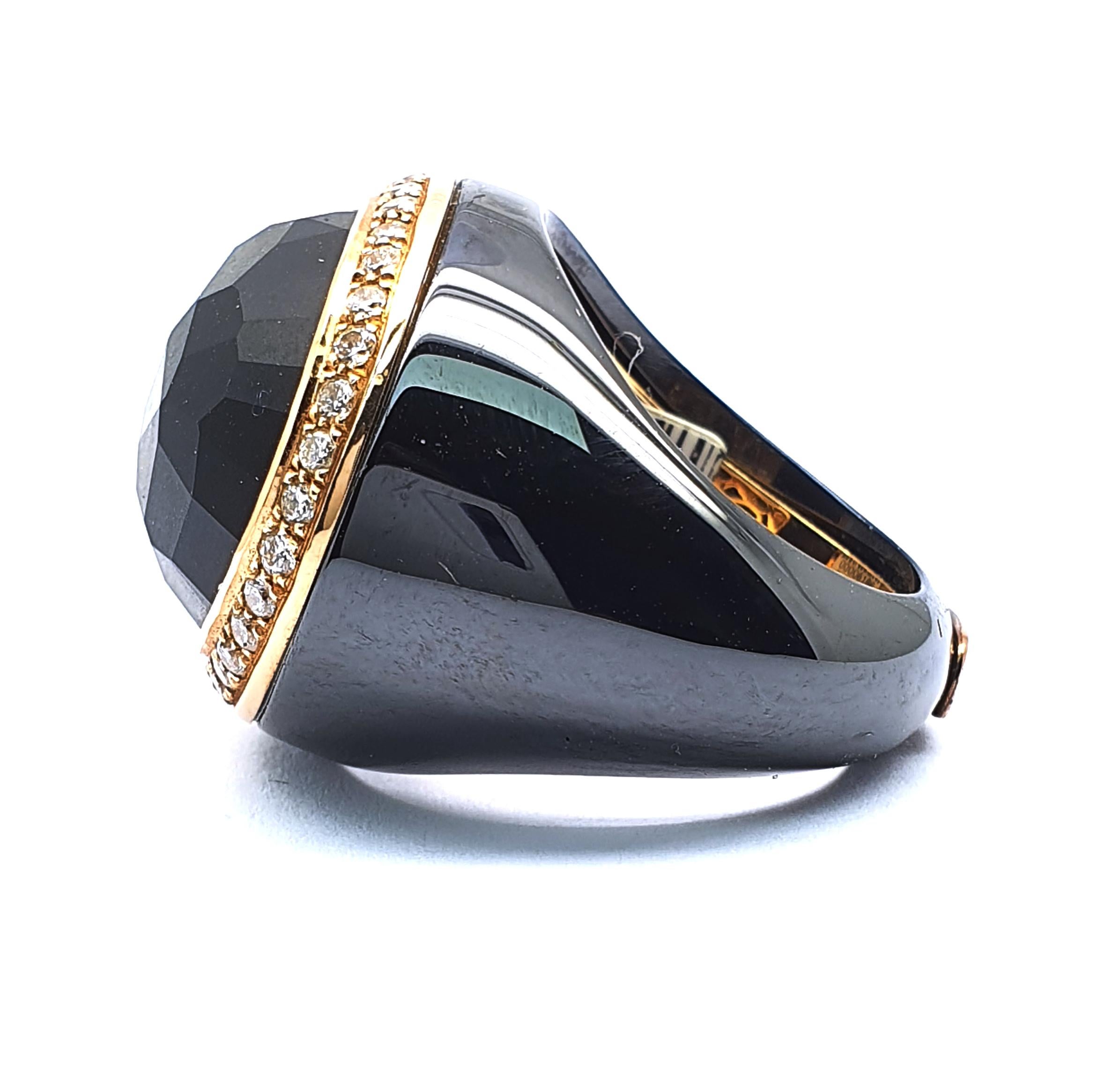 Using different materials and still sticking to the same colors strengthens the centre stones unique shape and size. This is a  black ceramic ring with a carved git center stone and an entourage of 0.90 carat brilliant cut diamonds in in color H/G