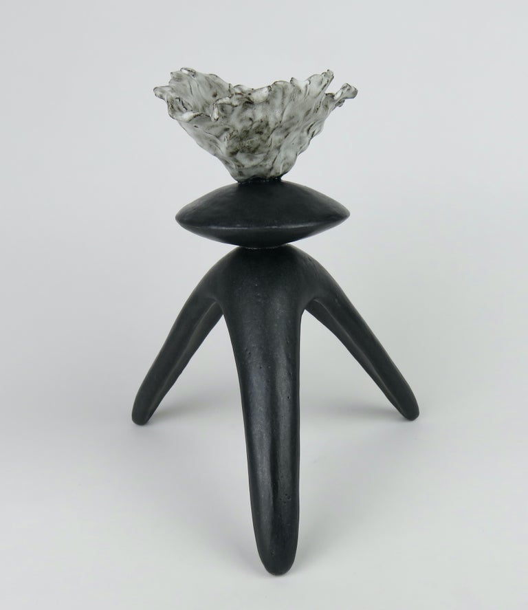 This glazed black hand built ceramic modern TOTEM consists of a freeform open top with a middle spherical shape on tripod legs. Part of a series of Modern Totemic works. 
The dark brown stoneware clay is hand formed in 3 sections which are attached