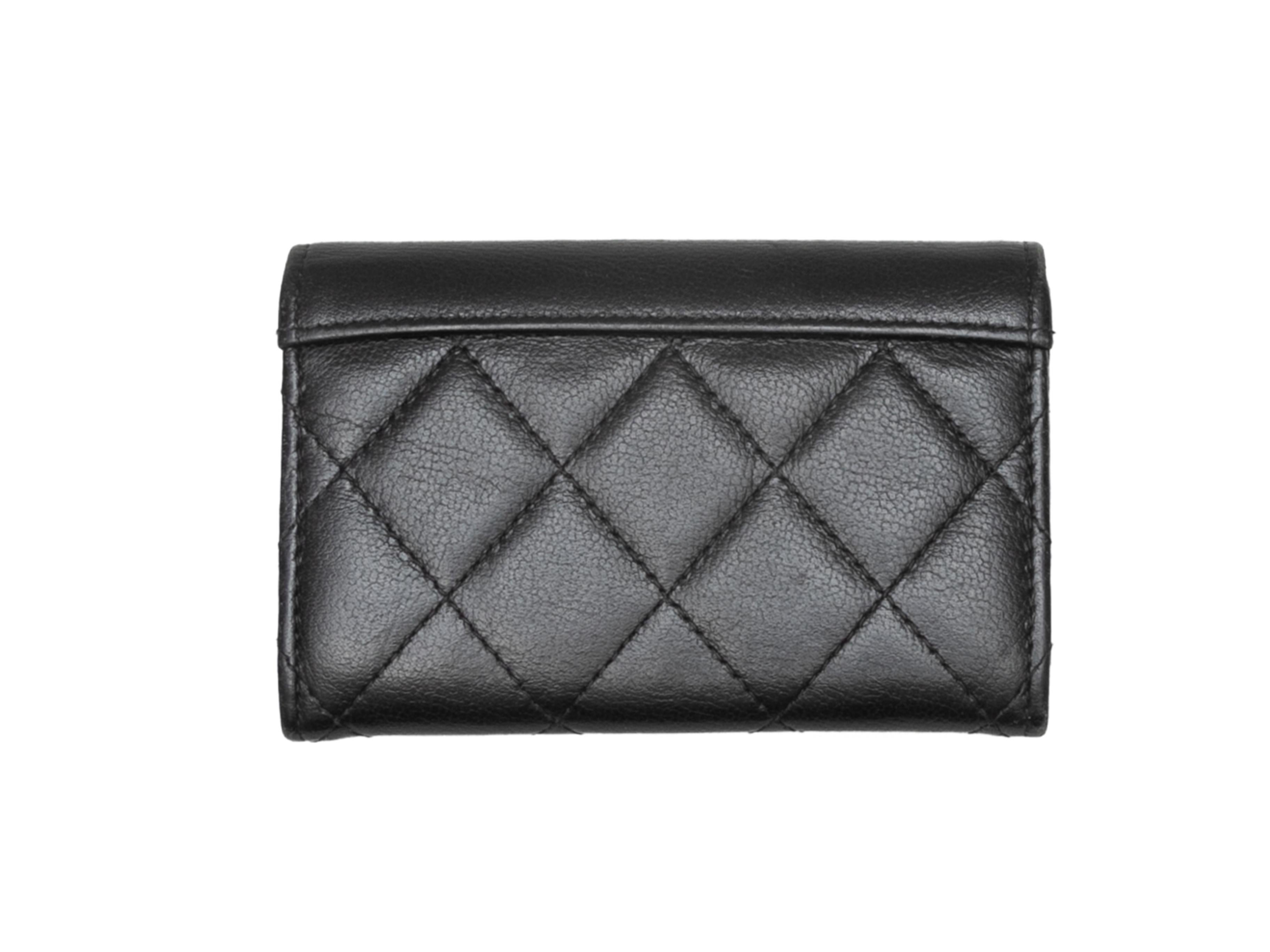 Black quilted leather small CC card holder by Chanel. Circa 2019. Front clasp closure. 3.5