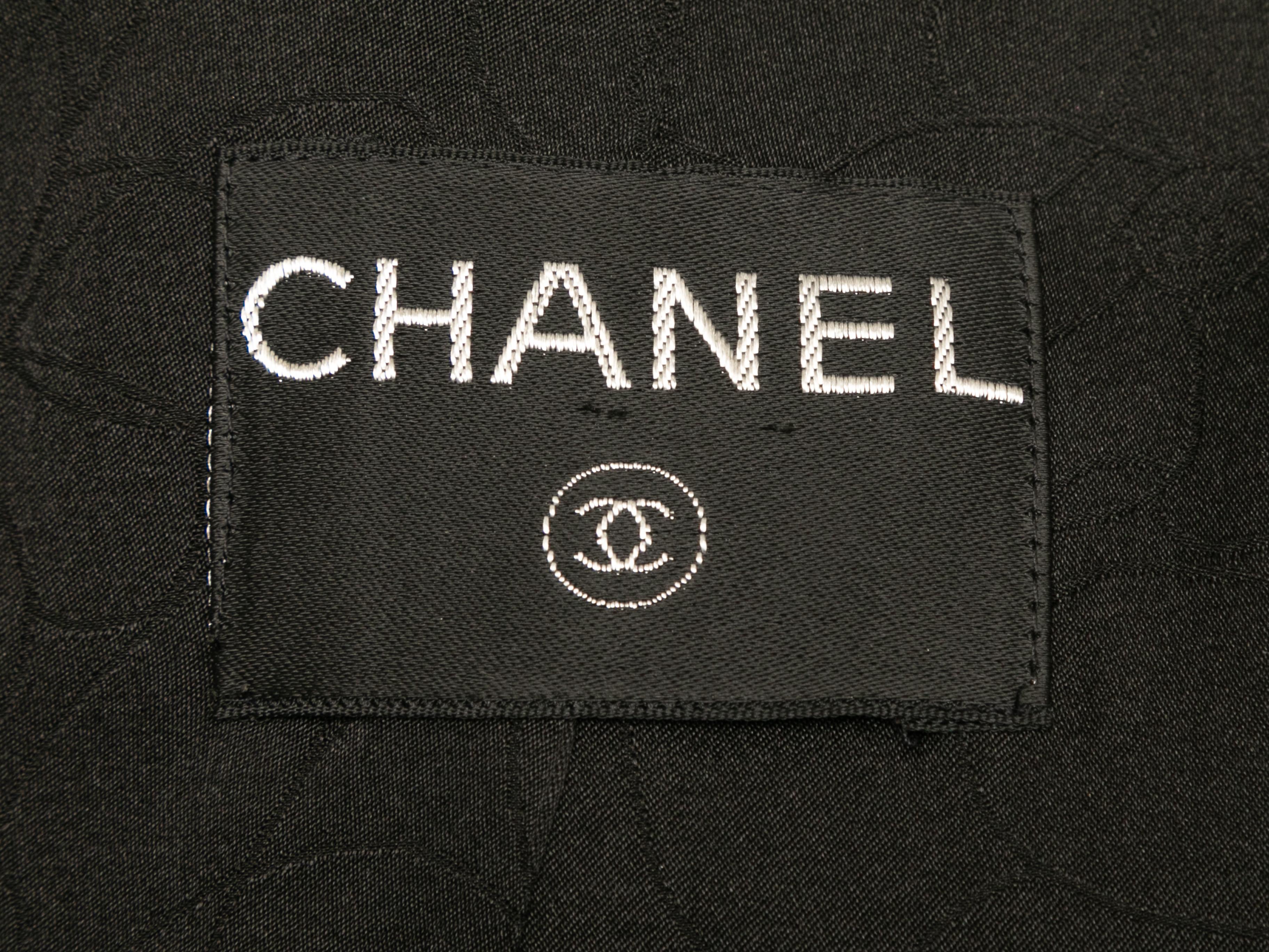 Black boucle double-breasted jacket by Chanel. Asymmetrical collar. Button closures at front. 36