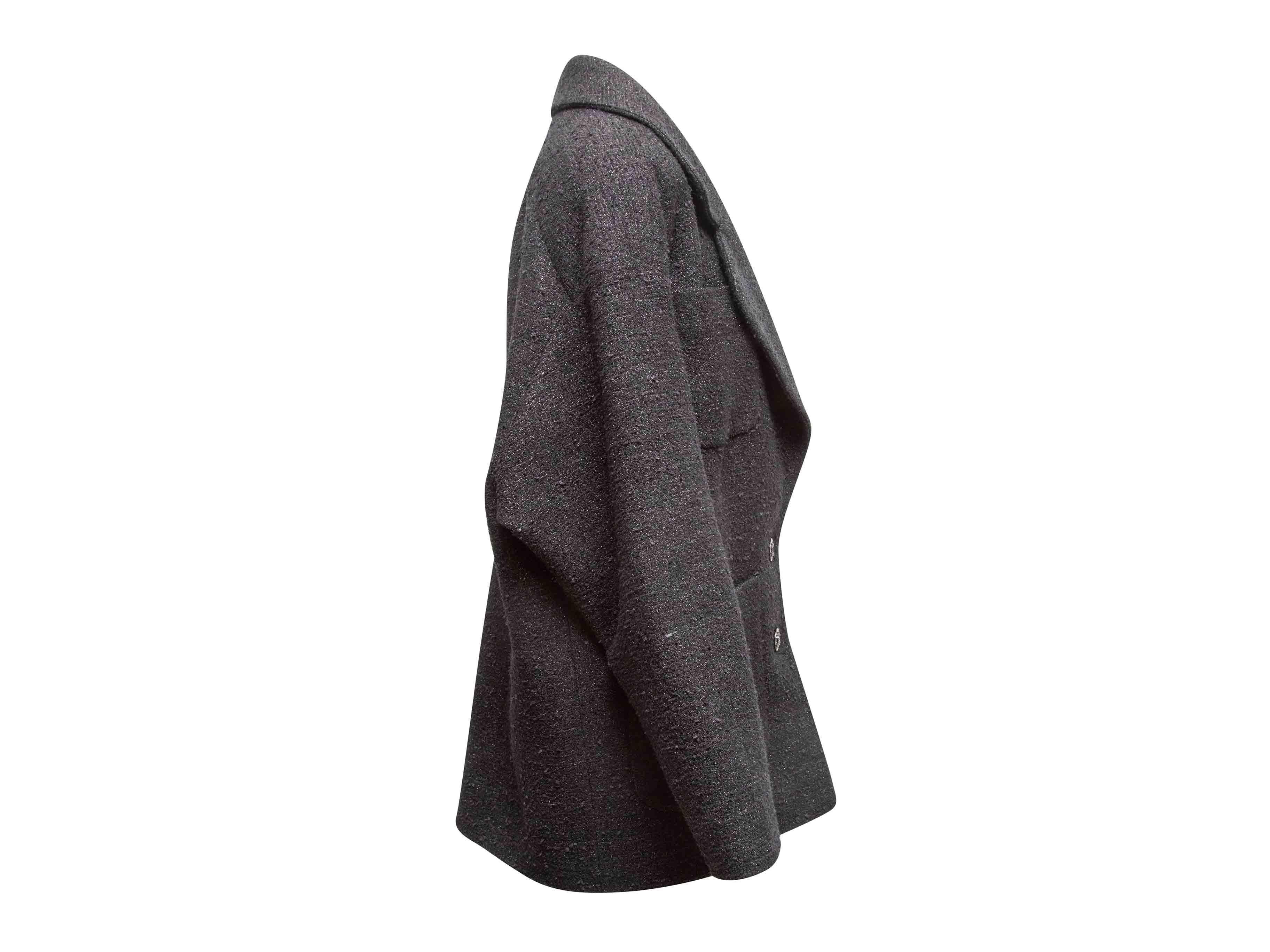 Giacca nera con bottoni di Chanel. Risvolto arrotondato con intaglio. Quattro tasche anteriori. Chiusura frontale con bottoni. Busto 41
