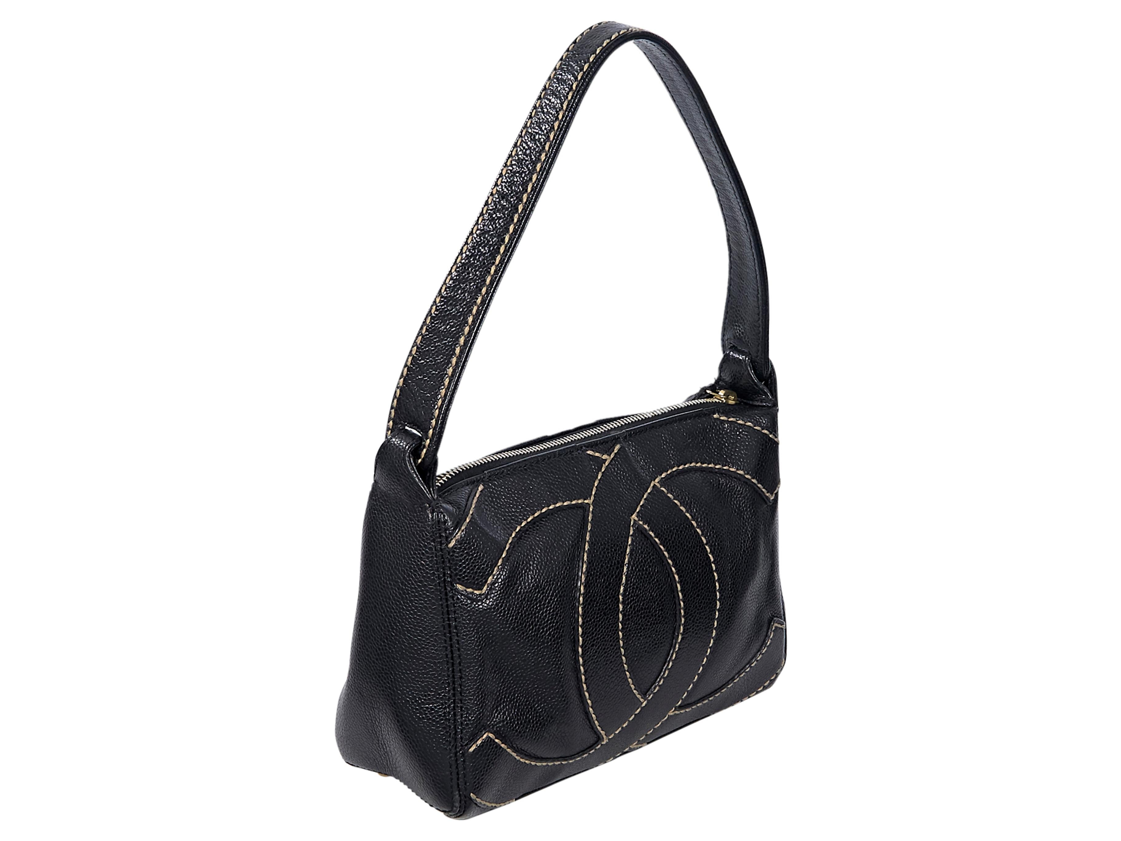 Product details:  Black leather CC logo embossed shoulder bag by Chanel.  Contrast stitching. Single shoulder strap. Top zip closure. Lined interior with inner slide and zip pockets.  Protective metal feet.  Gold-tone hardware. 9