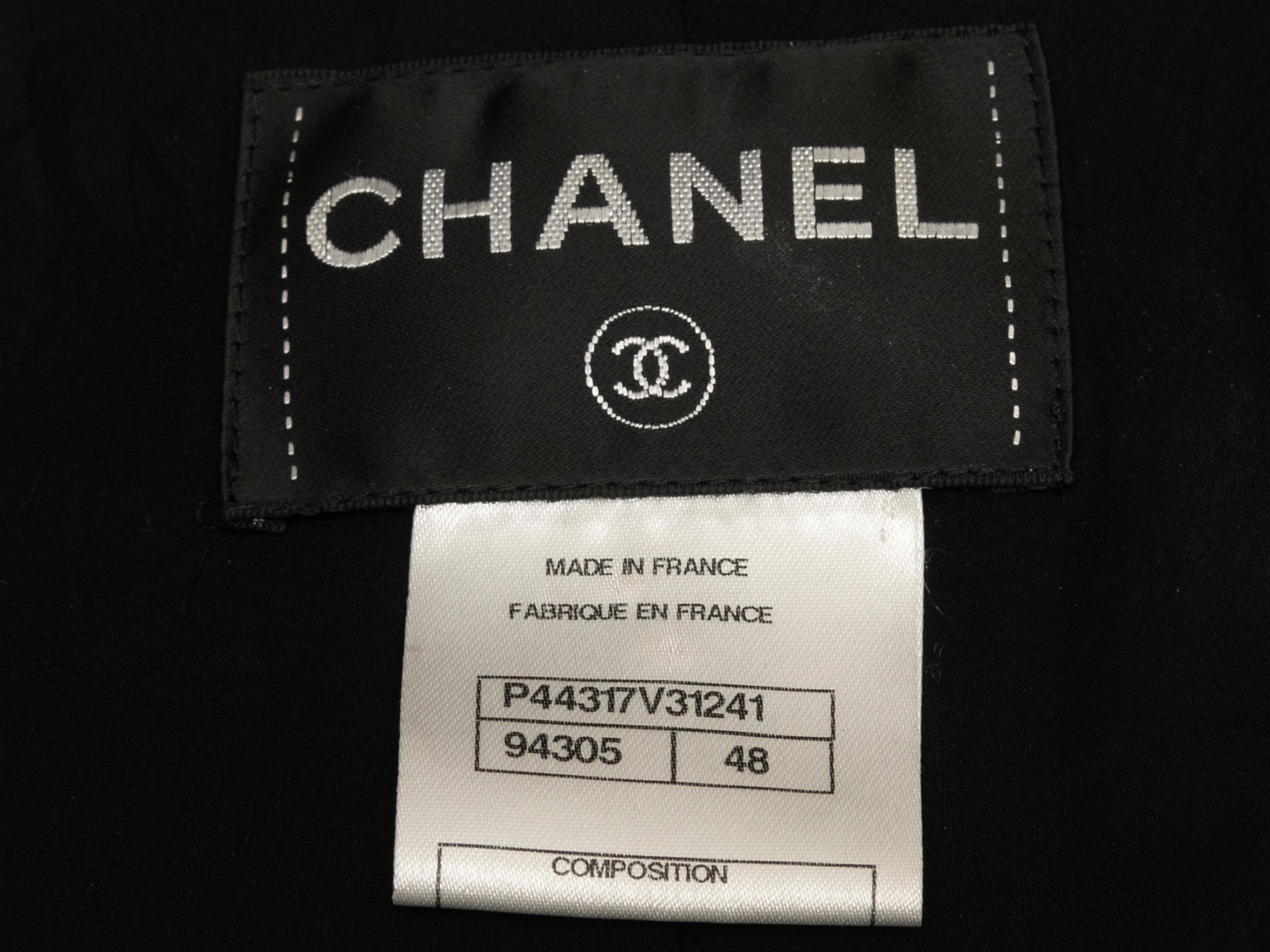 Black double-breasted wool jacket by Chanel. Wide mock neck. Dual hip pockets. Button closures at front. 36