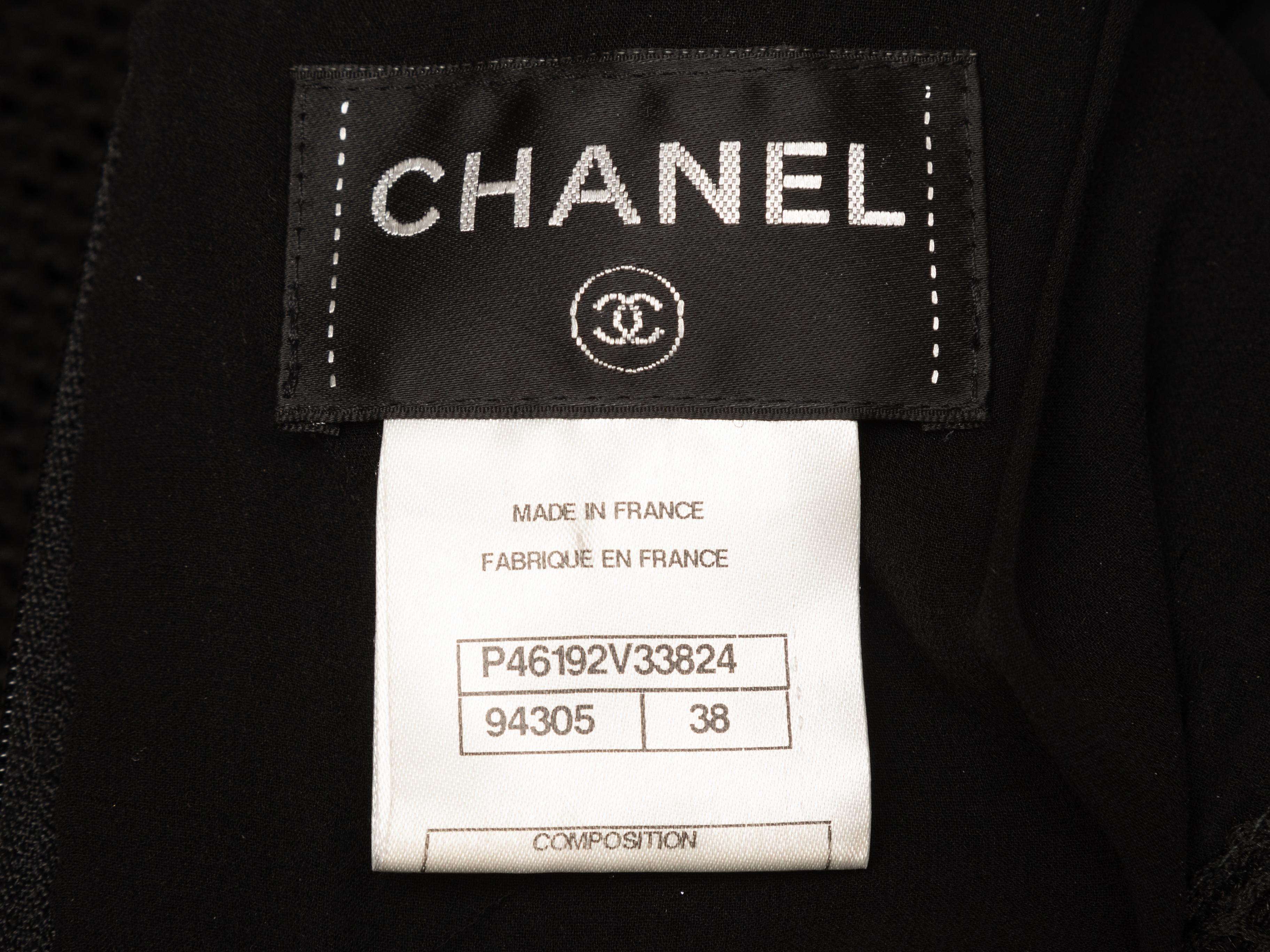 Black mesh fitted dress by Chanel. Circa early 2000s. Crew neck. Cap sleeves. Dual hip pockets. Zip closure at back. Designer size 38. 26