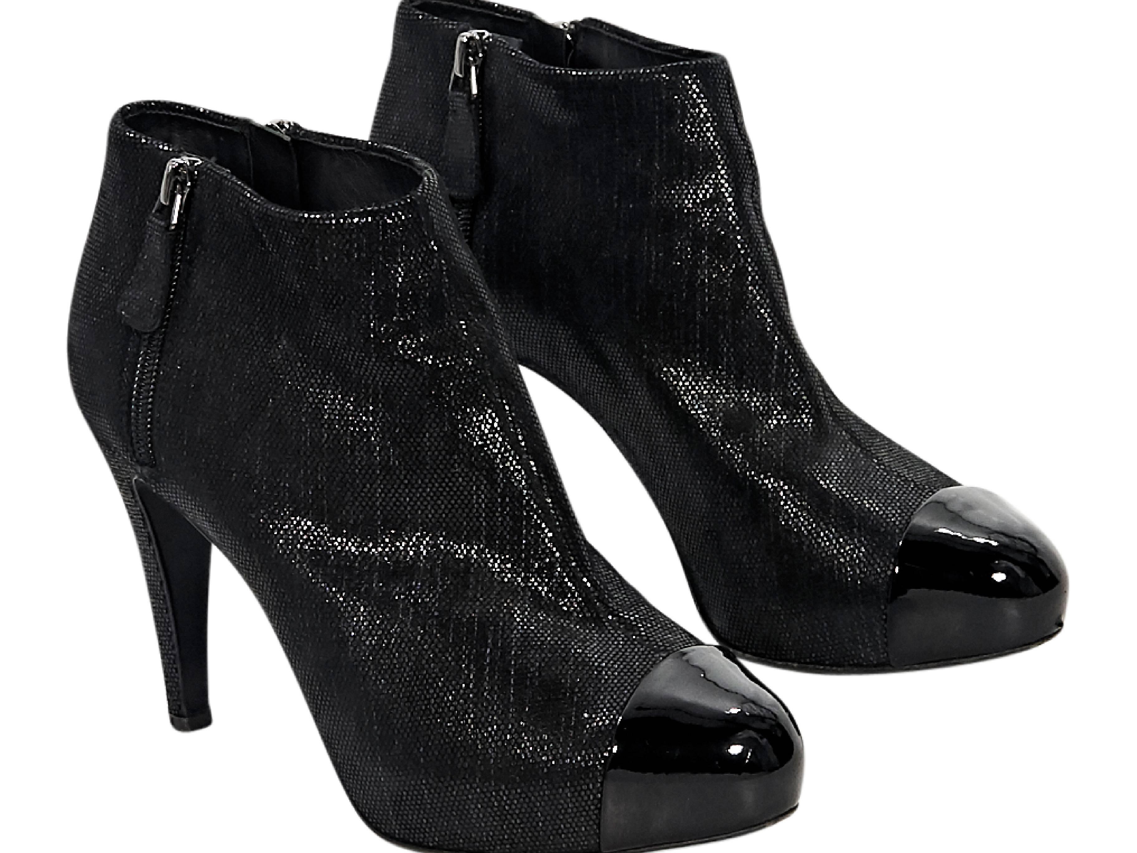 Product details:  Black embossed ankle boots by Chanel.  Outer and inner zip closures.  Round patent leather cap toe.  Concealed platform. 
Condition: Pre-owned. Very good. 
Est. Retail $ 1,795.00