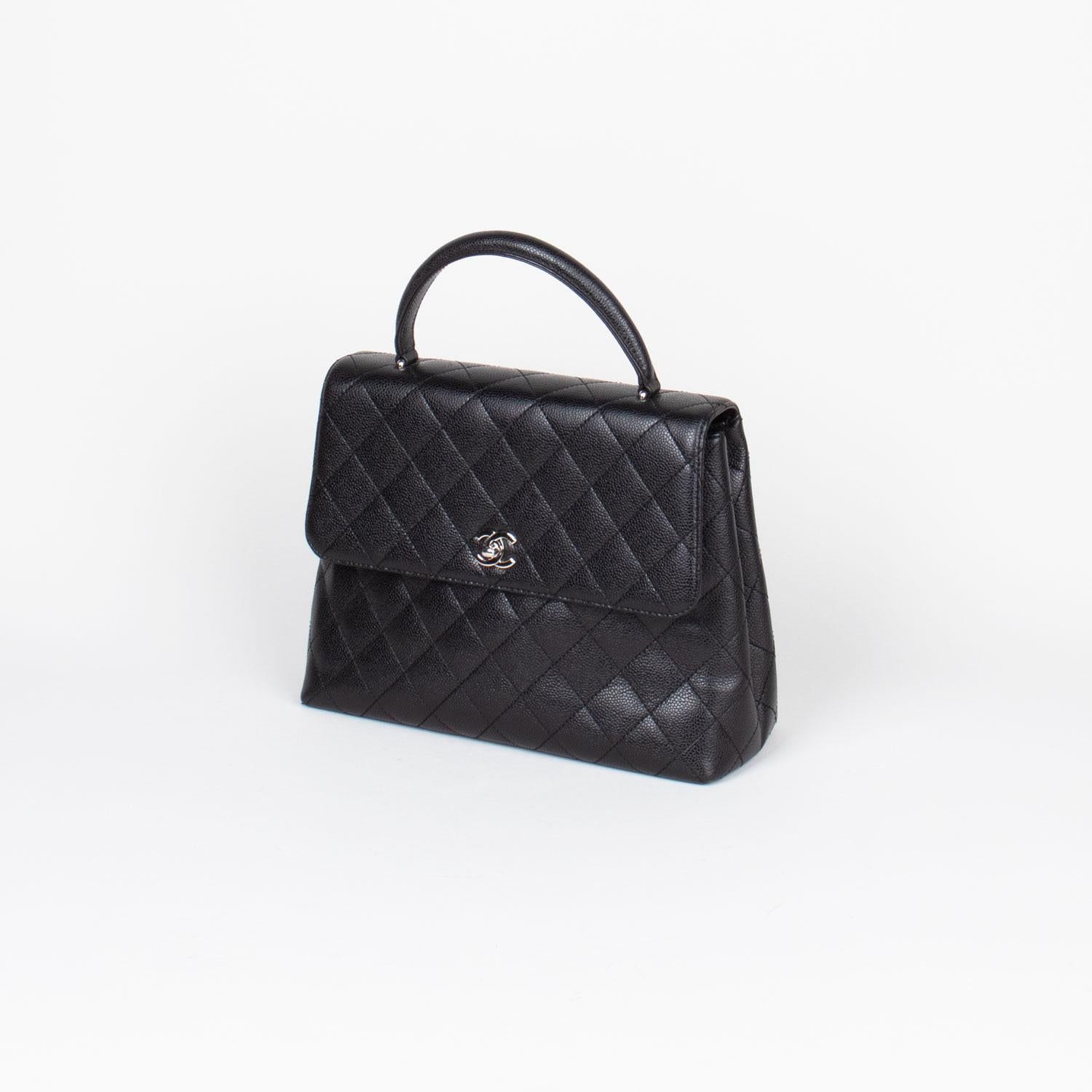 Black quilted caviar leather Chanel Kelly Bag with

- Silver-tone hardware
- Single semi-rolled top handle
- Tonal leather lining
- Dual interior pockets; one with zip closure and signature CC turn-lock closure at front flap
- Dual interior