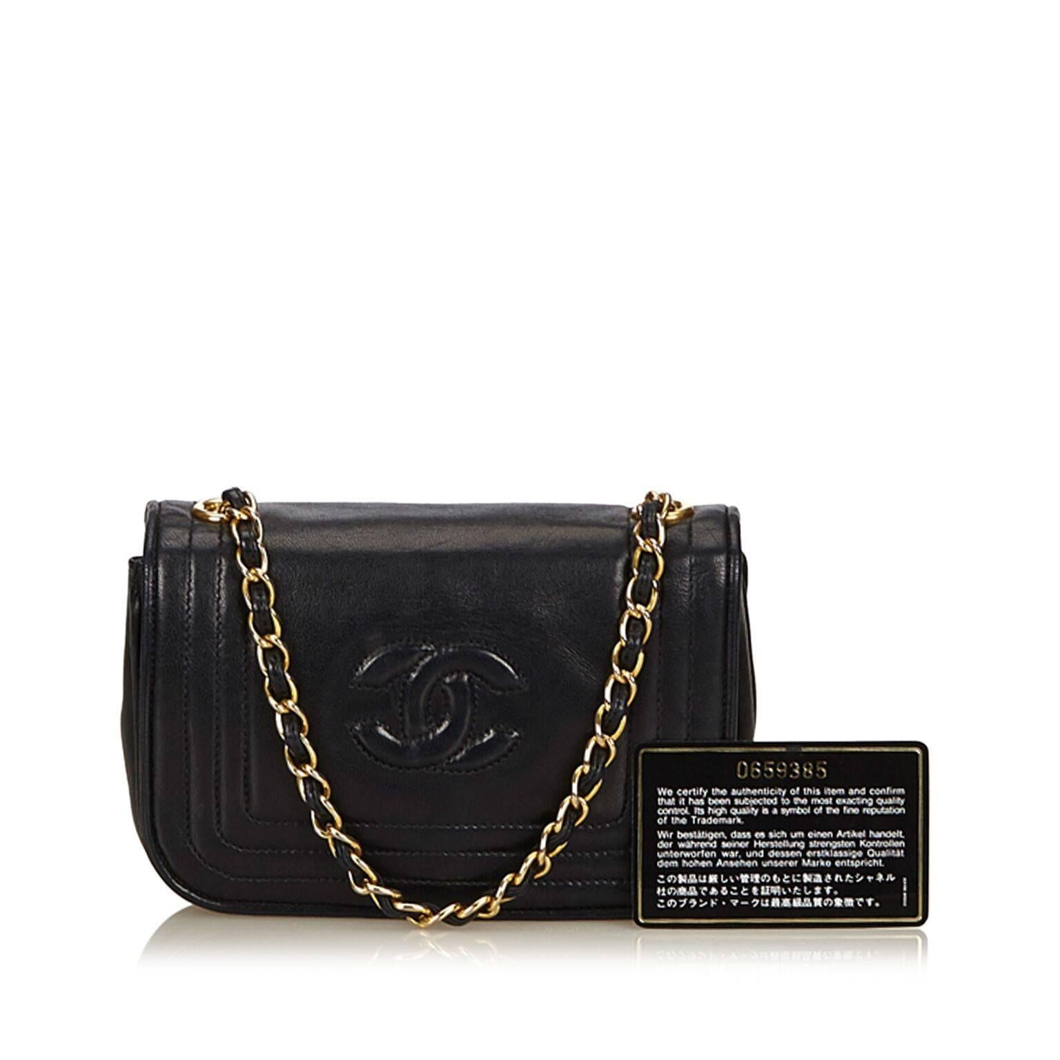 Product details:  Black lambskin leather flap bag by Chanel.  Single chain shoulder strap.  Front flap with magnetic snap closure.  Leather interior with inner zip pocket.  Goldtone hardware.  7