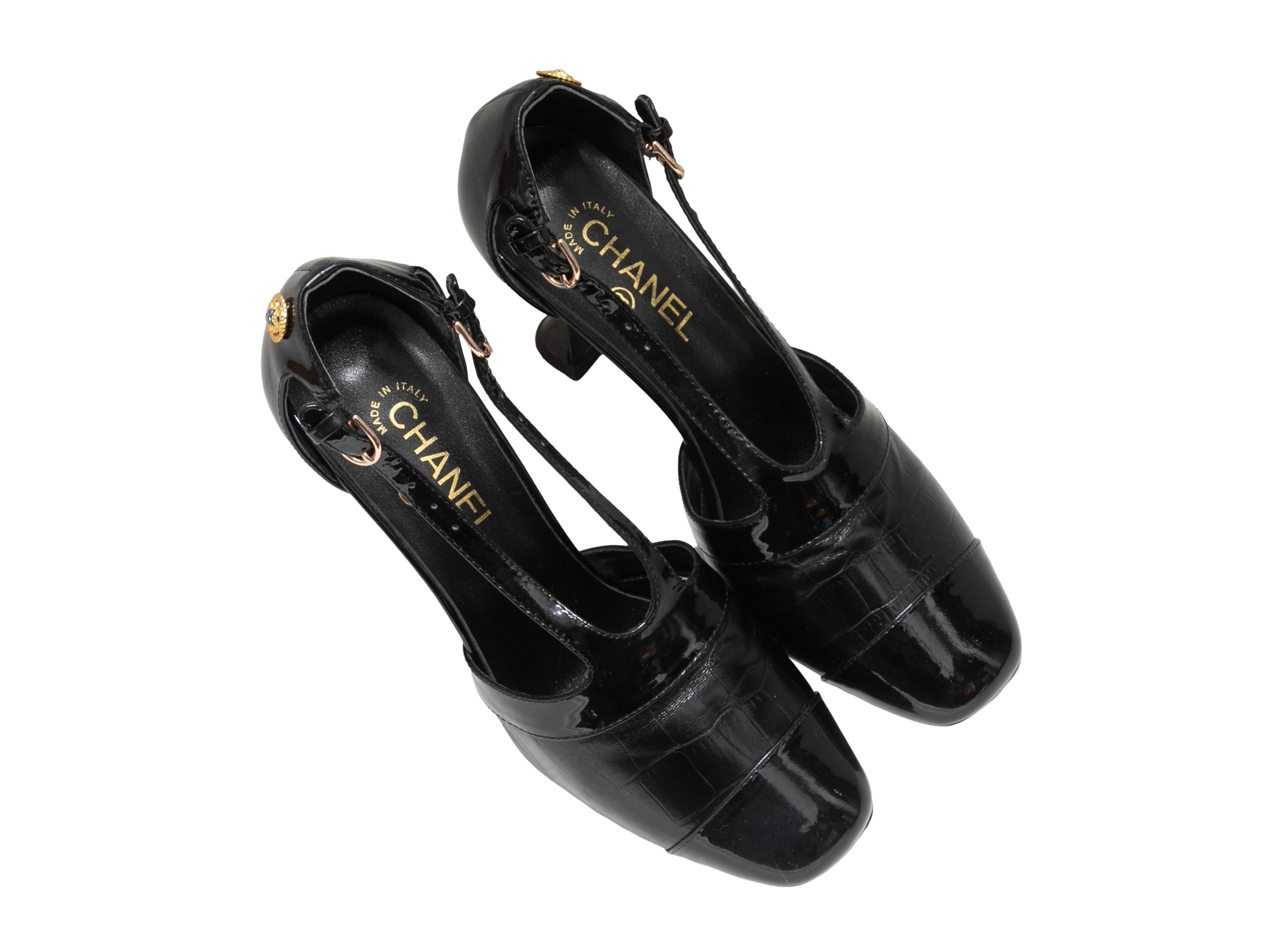 Black patent and embossed leather cutout pumps by Chanel. Circa 2019. Gold-tone hardware. Buckle closures at ankle straps. 3.5