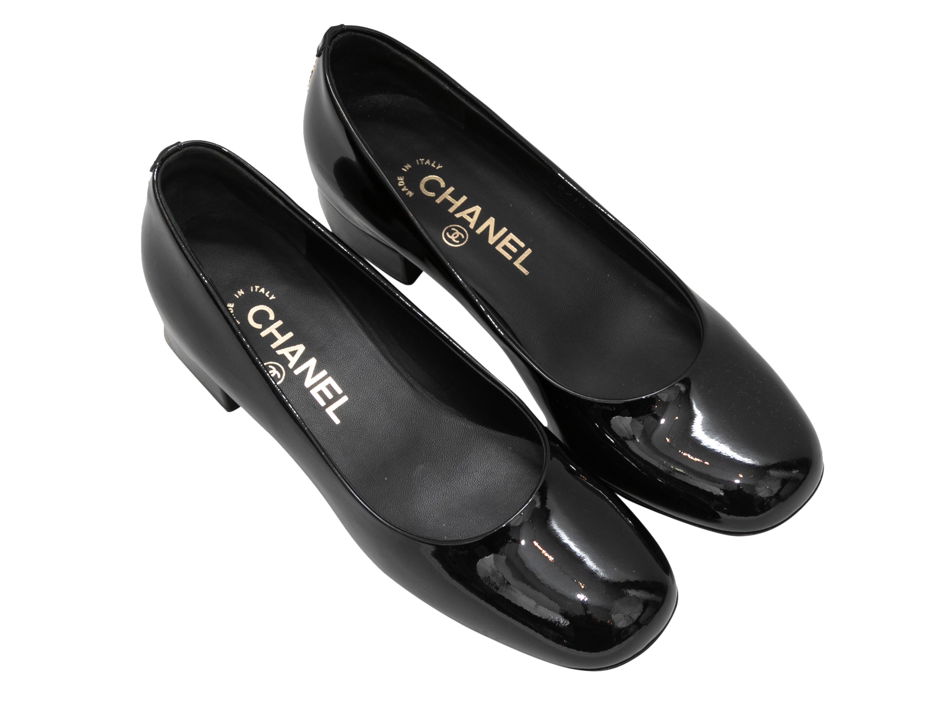 Black patent leather low block heel pumps by Chanel. 1.25