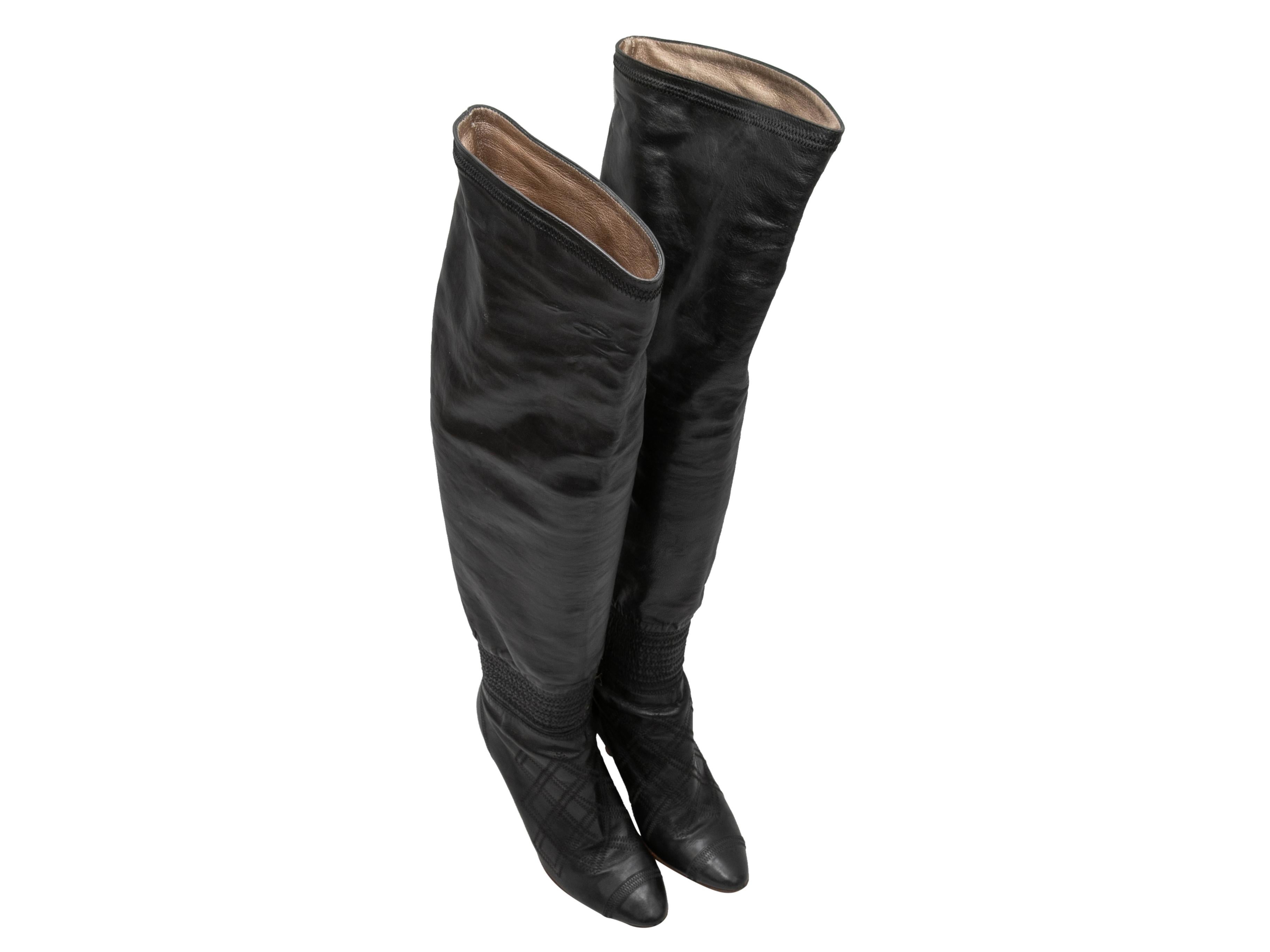 Black leather pointed-toe knee-high smocked boots by Chanel. Tan covered heels. 20