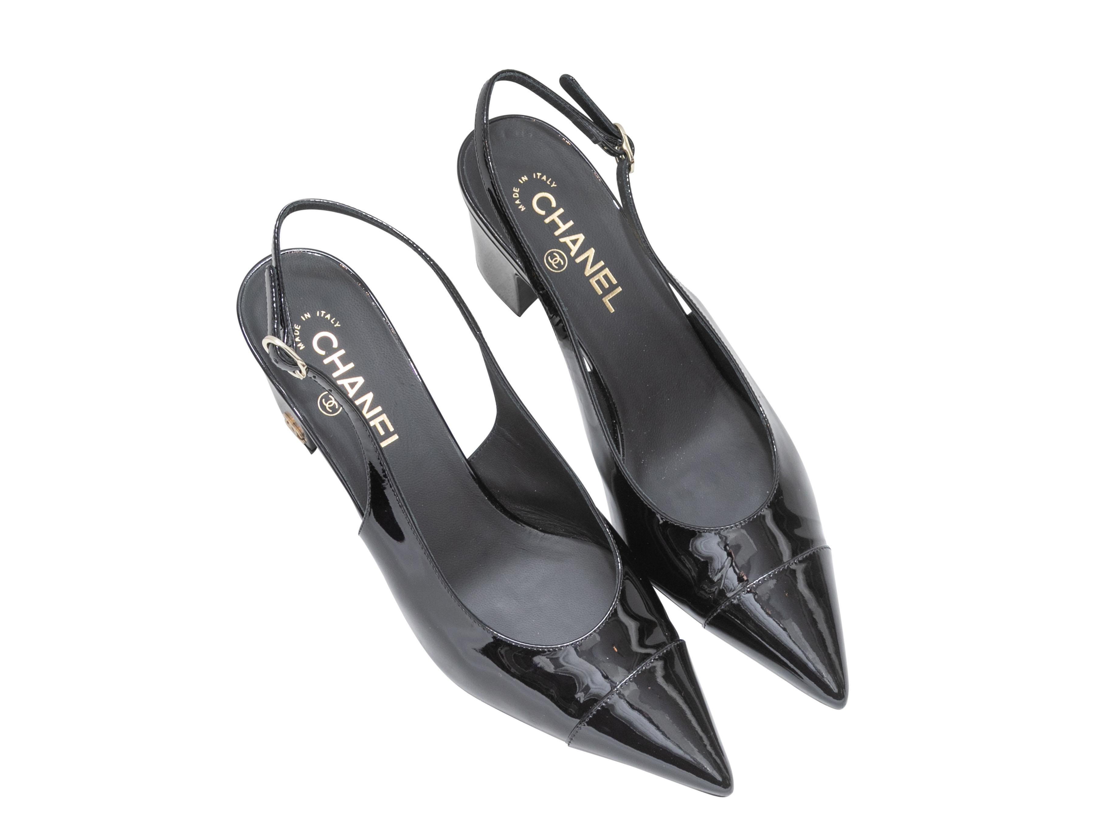 Black pointed-toe patent slingbacks by Chanel. Buckle closures at slingback straps. 2.5