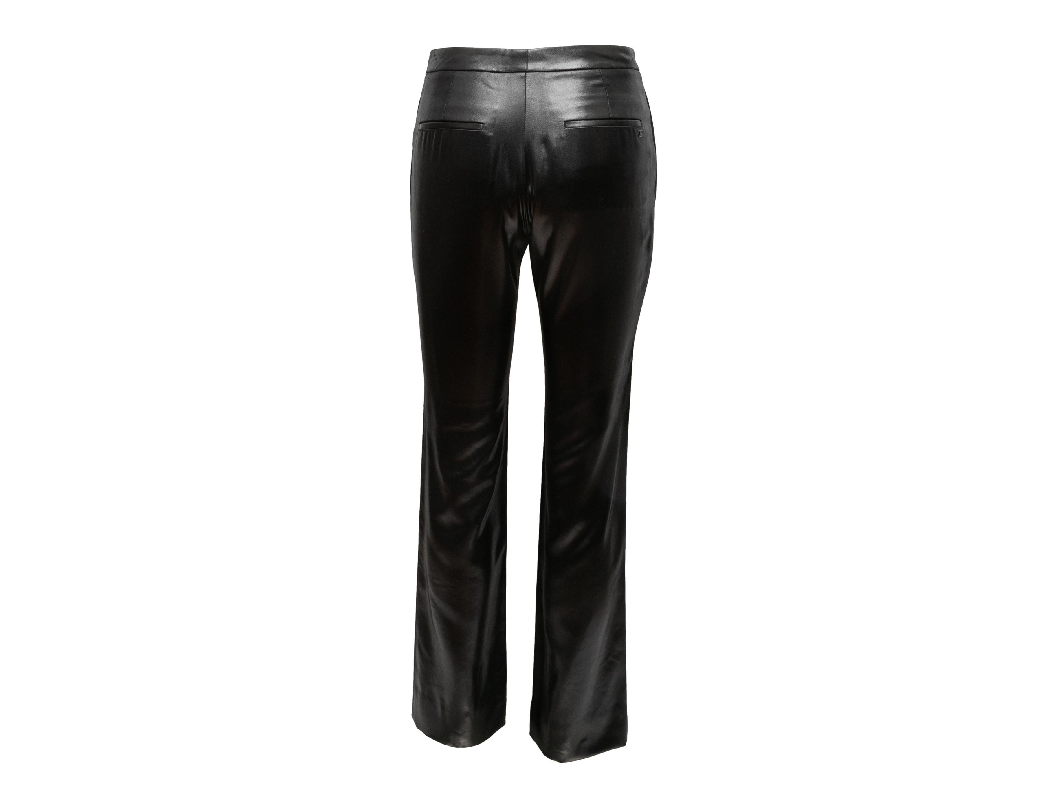 Black shiny straight-leg trousers by Chanel. From the Spring/Summer 2009 Collection. Four pockets. Zip closure at front. 25