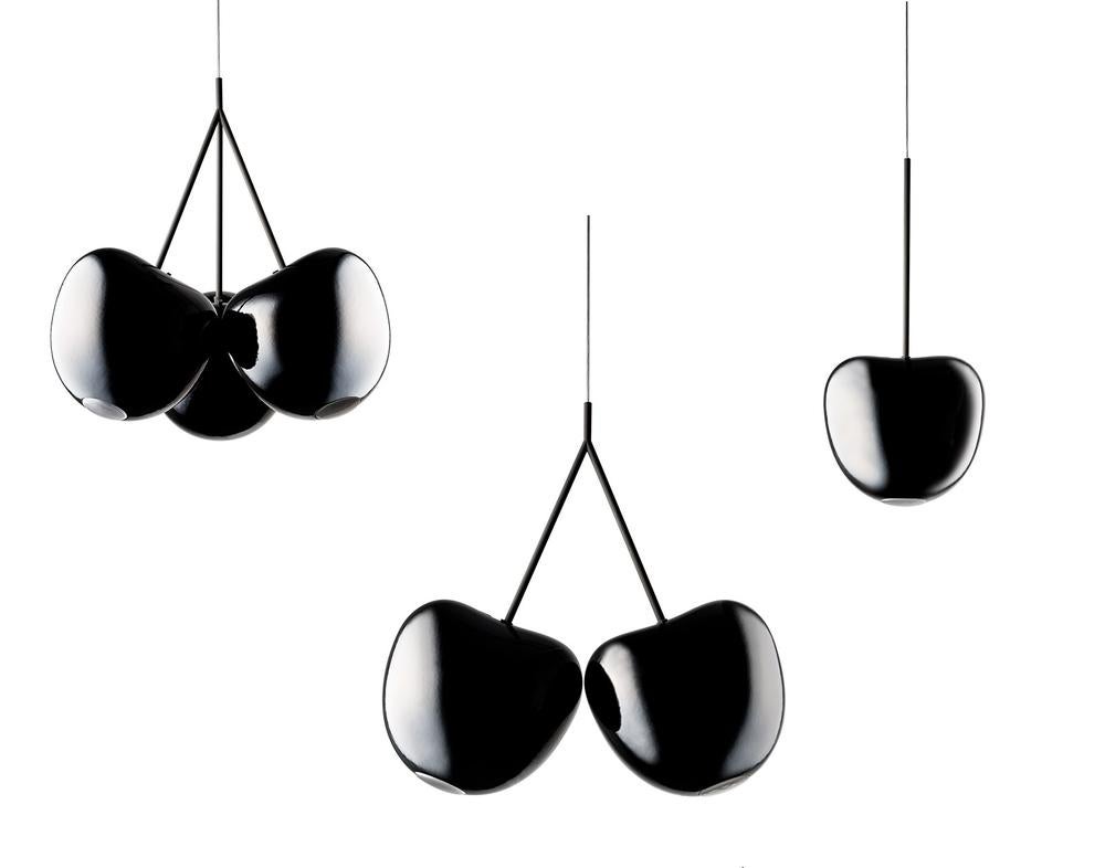 Every single cherry in the world was blessed with a shape that is both simple and mysterious. It has curves that flirt and has the nerve to suggest. Ah, cherries! This modular assembly of lamps pays homage to them all. Simple in design and generous