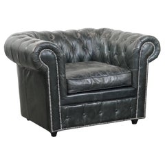 Black Chesterfield armchair made of grained cowhide leather